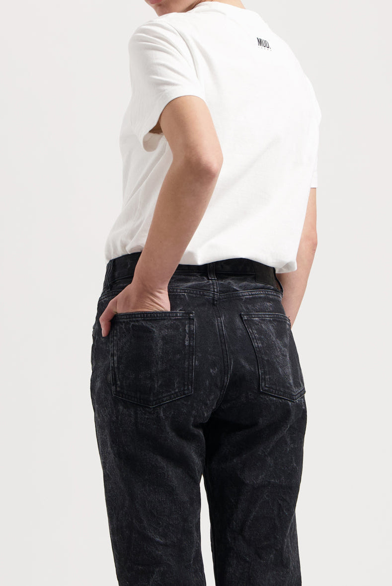 Sustainable MUD Jeans in light blue denim, ethical classic fit, paired with a crisp white T-shirt, rear view.