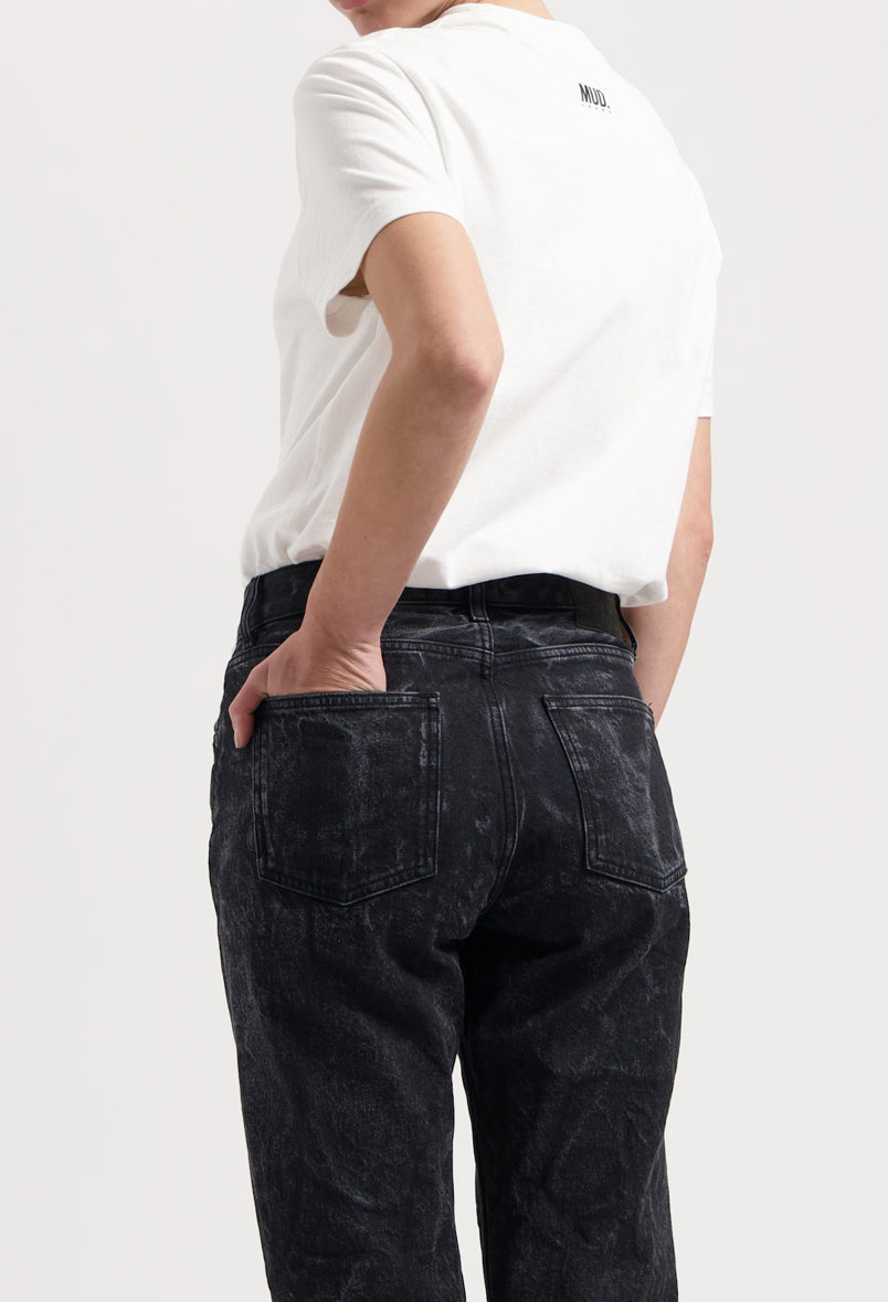 Sustainable MUD Jeans in light blue denim, ethical classic fit, paired with a crisp white T-shirt, rear view.