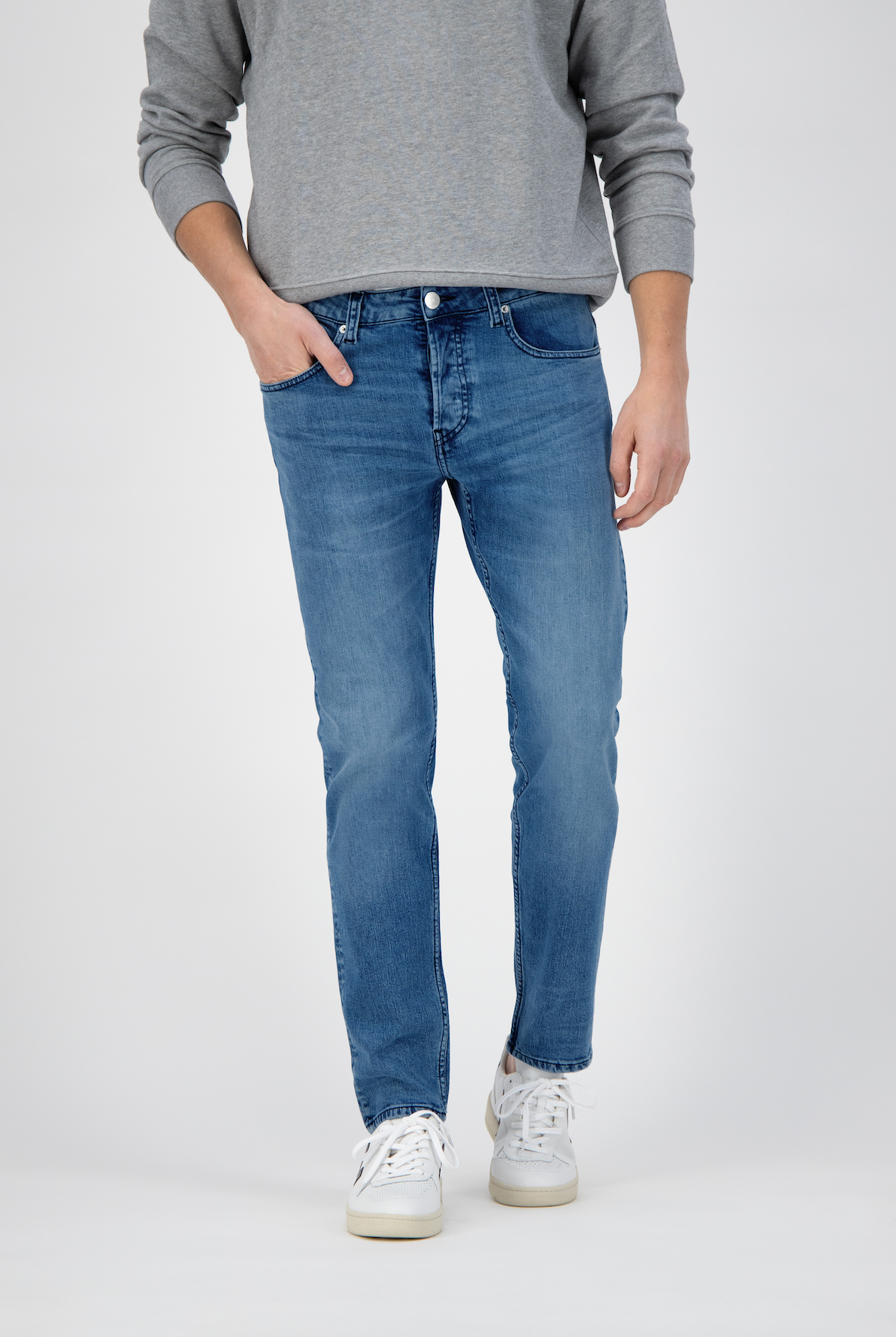 Sustainable MUD Jeans in dark blue denim with visible stitching, highlighting ethical fashion with a stylish fit.