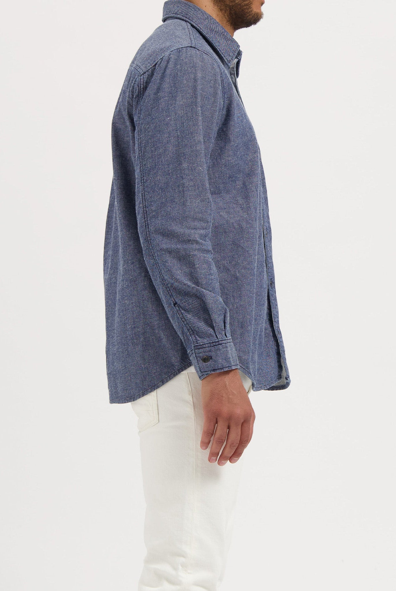 Sustainable MUD Jeans featuring dark blue denim, crafted from ethical materials, shown with a black t-shirt.