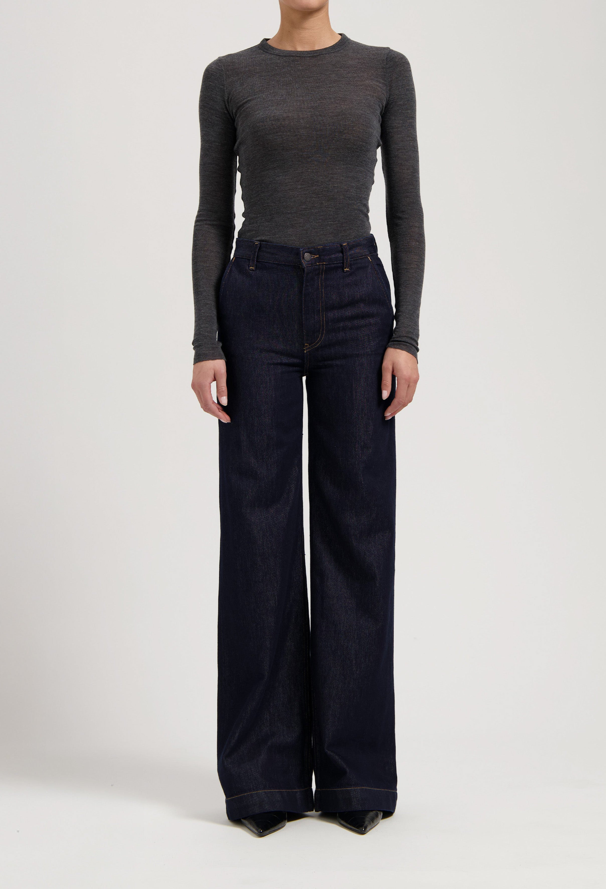 Gray long-sleeve fitted top with wide-leg dark blue denim jeans, emphasizing a casual and stylish look.