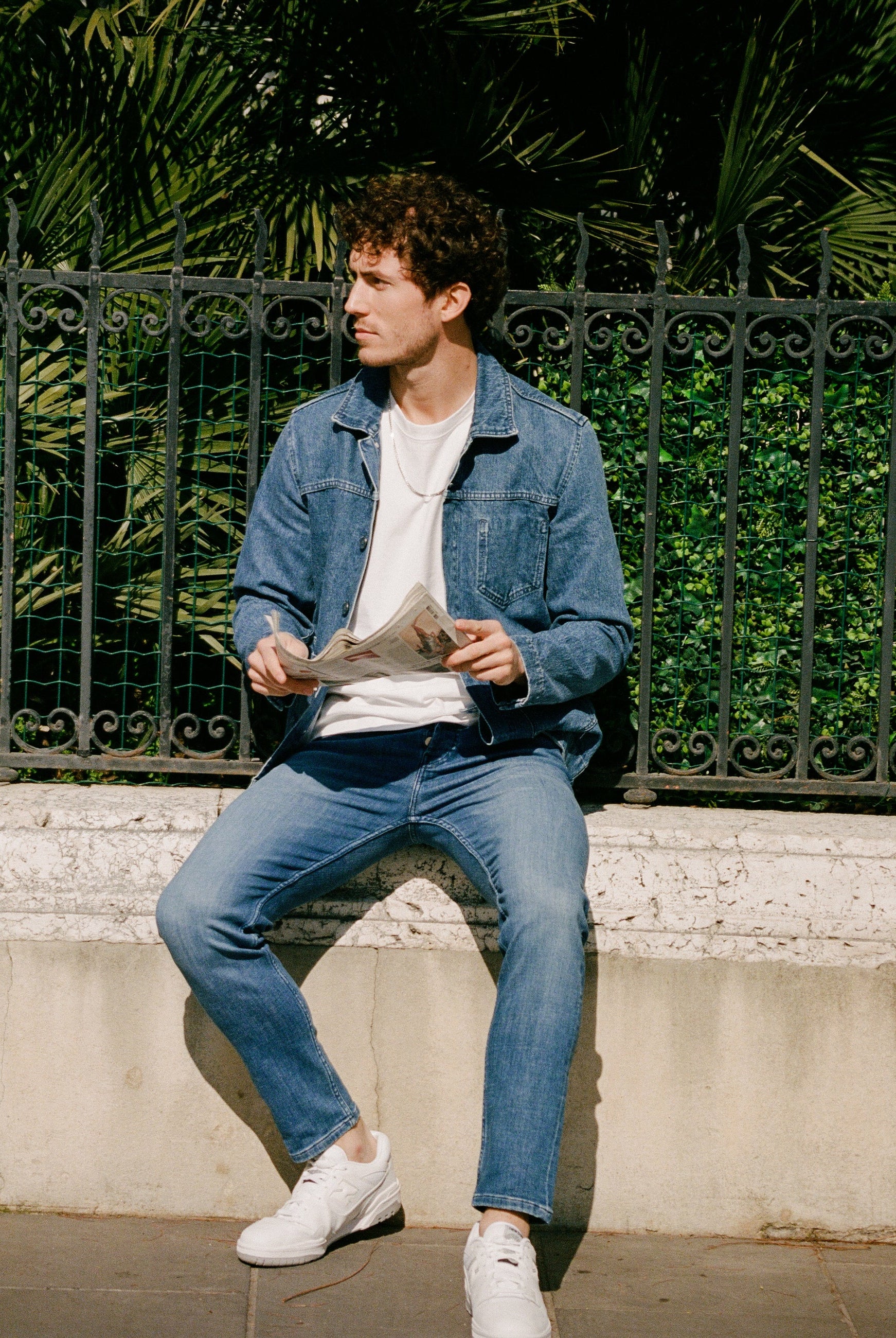 Sustainable MUD Jeans made from organic cotton, featuring dark blue denim in a relaxed fit with black leather boots.