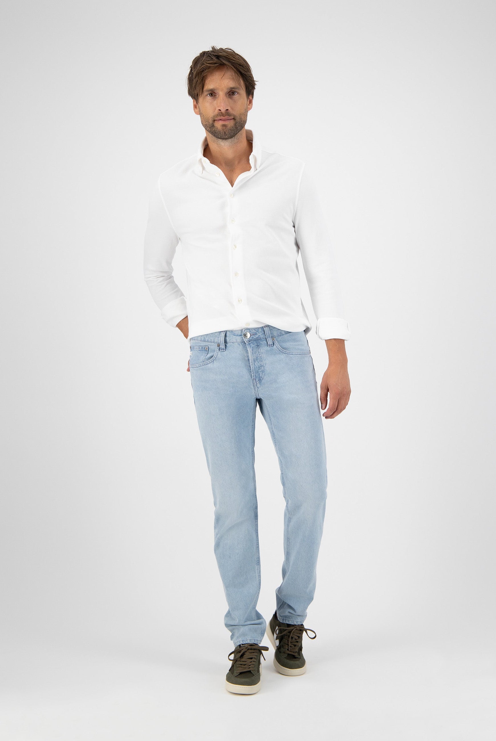 Sustainable MUD Jeans in light blue denim, crafted from organic cotton, showcasing a relaxed fit and ethical design.