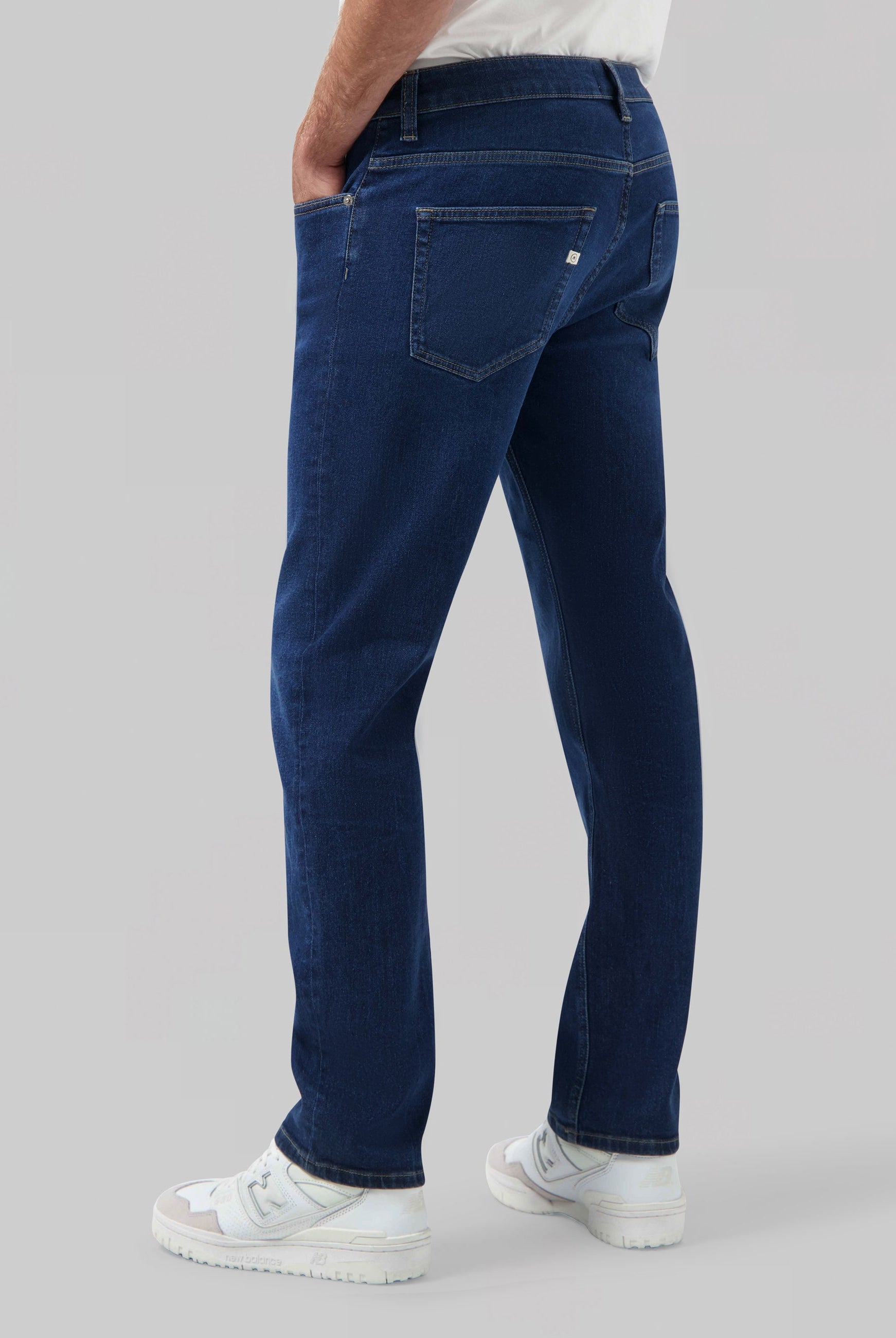 Sustainable MUD Jeans denim jacket in classic blue, worn with a matching blue cap, showcasing ethical fashion.