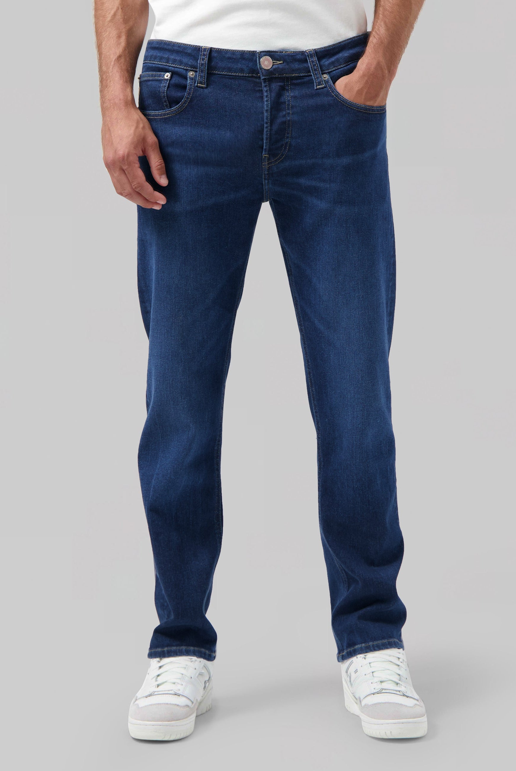 Sustainable MUD Jeans dark denim shirt paired with a blue cap, emphasizing ethical fashion and simple style.