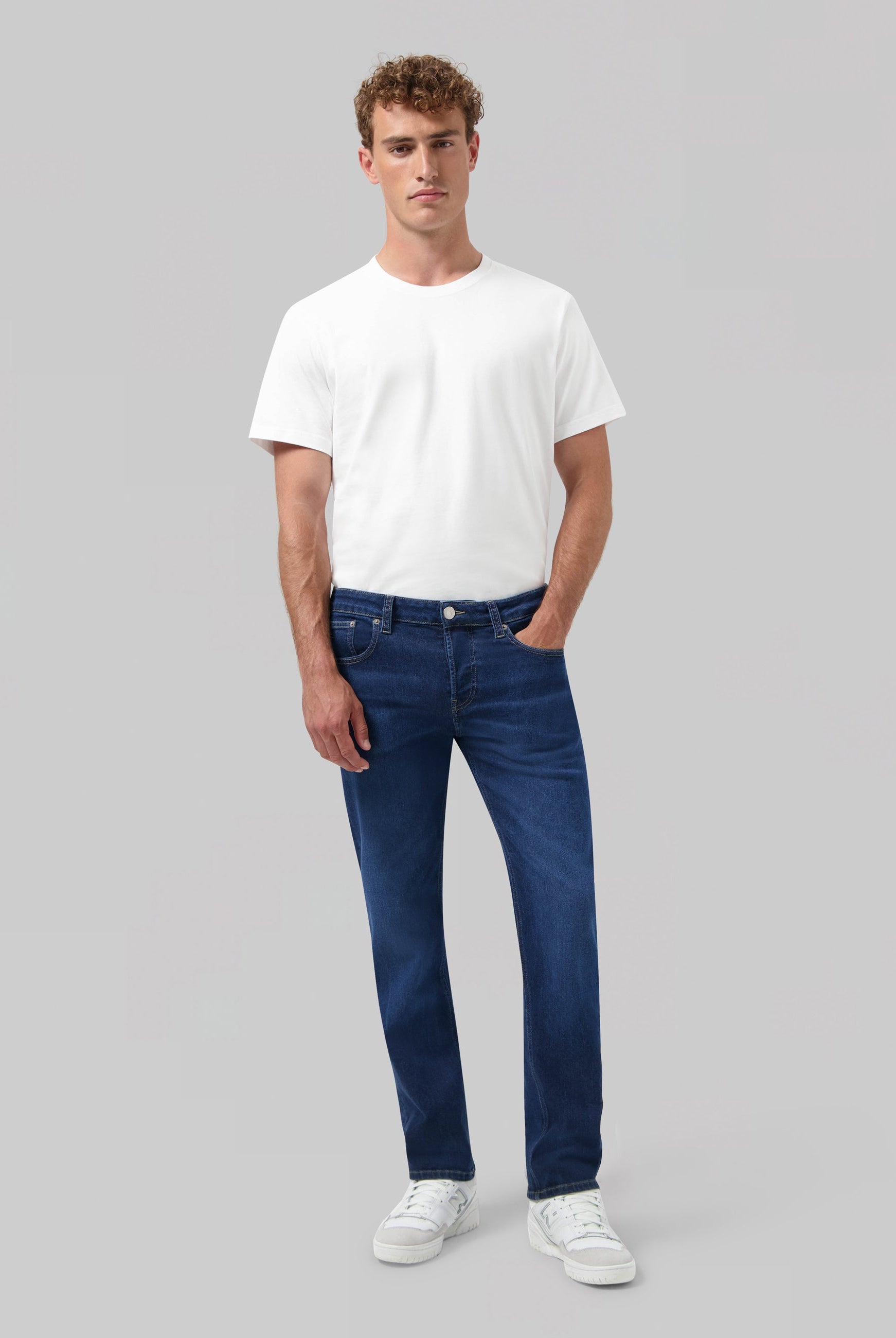 Sustainable blue denim jeans by MUD Jeans, featuring a classic fit, highlighting ethical fashion and organic materials.