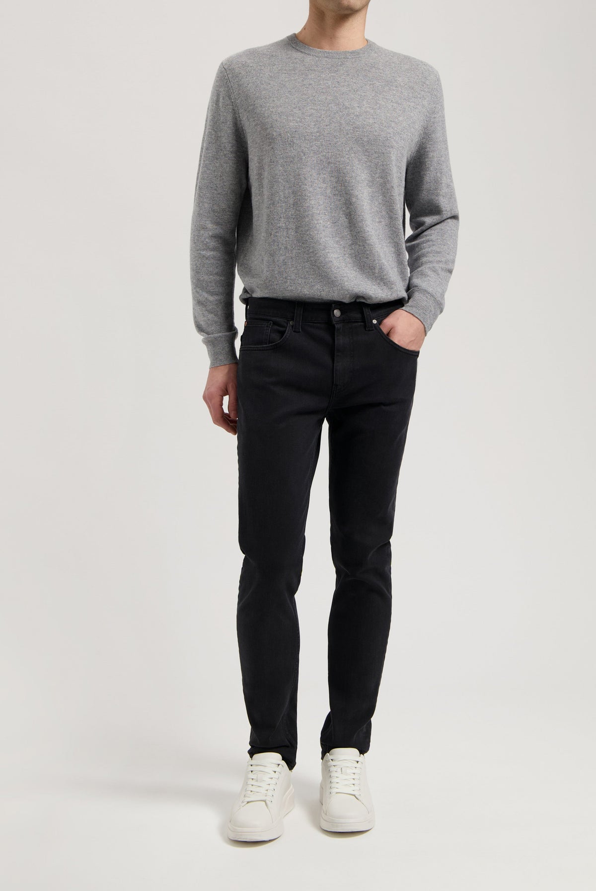 Sustainable MUD Jeans ensemble featuring dark denim shirt and blue jeans, highlighting ethical fashion in classic style.