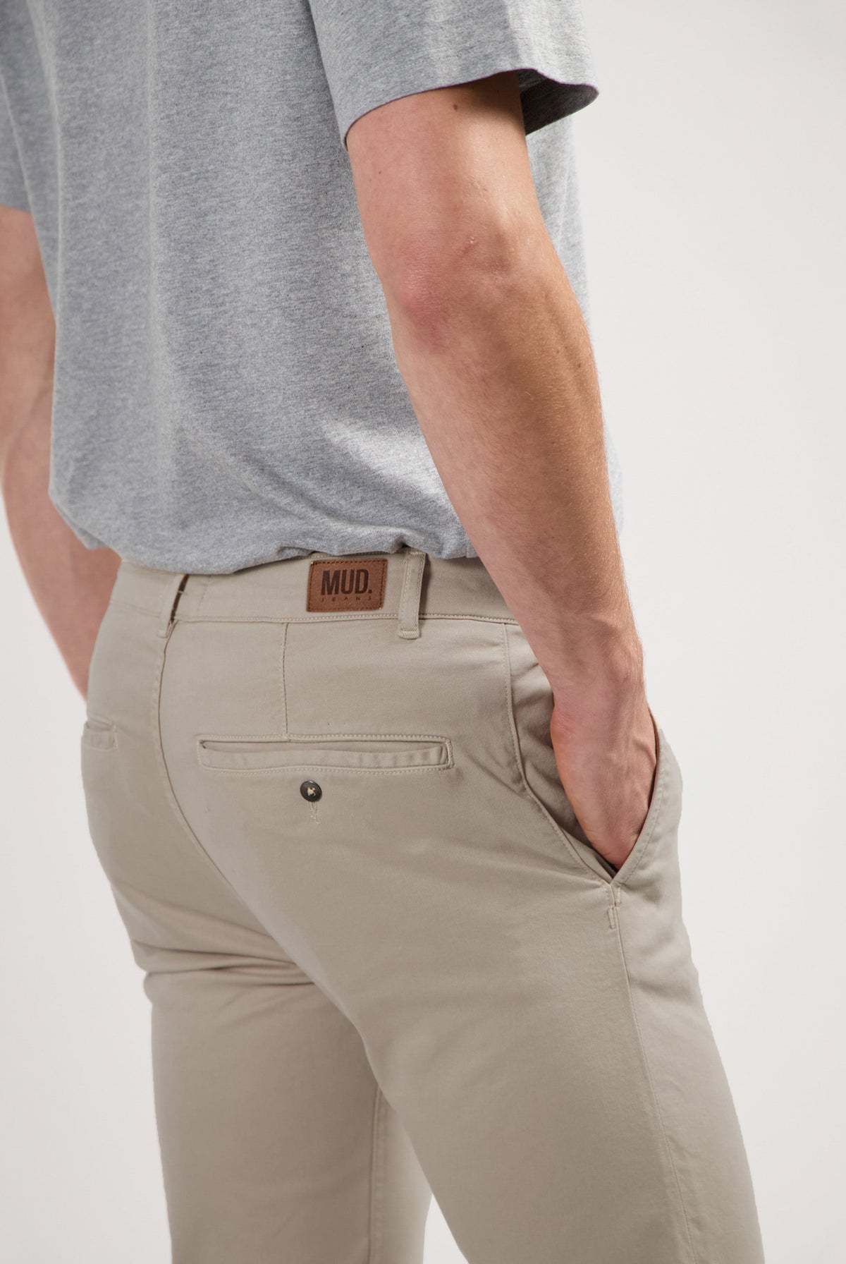 Sustainable MUD Jeans crafted from organic cotton in classic white, paired with a blue denim shirt for an ethical look.