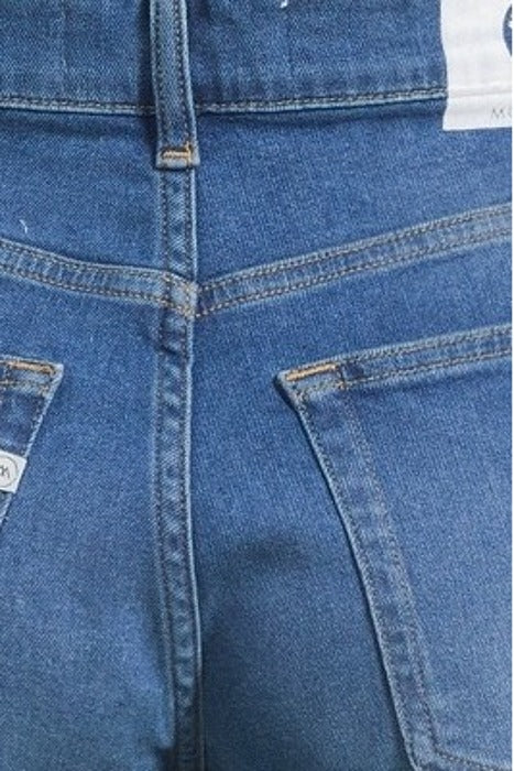 Rear view of blue denim jeans with visible stitching and back pockets, highlighting durable fabric and classic design.