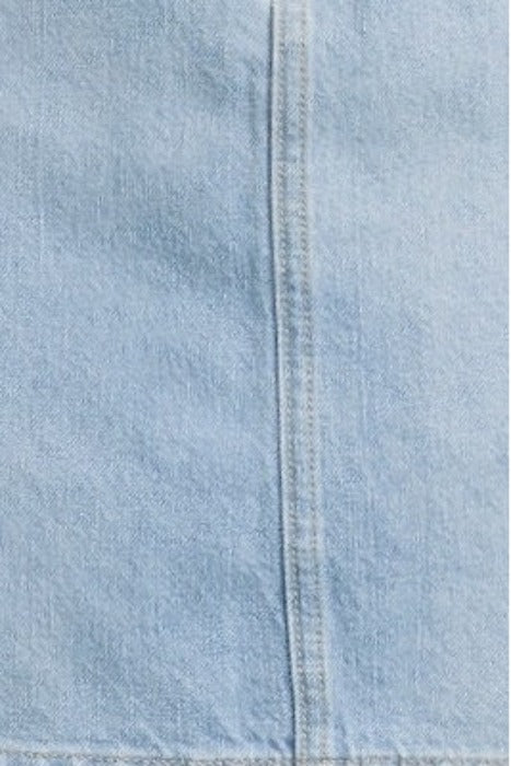 Light blue denim fabric close-up showing detailed stitching in vertical seam for casual fashion or upholstery use.