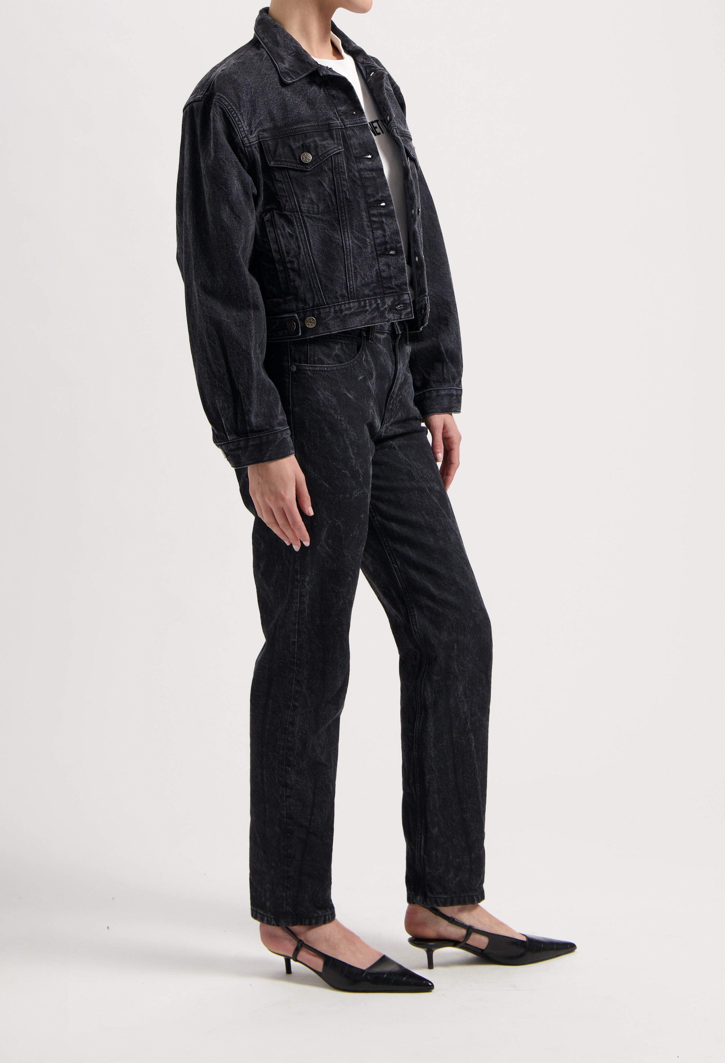 Black denim jacket and jeans set with a classic fit, paired with a white top and black pointed-toe kitten heels.