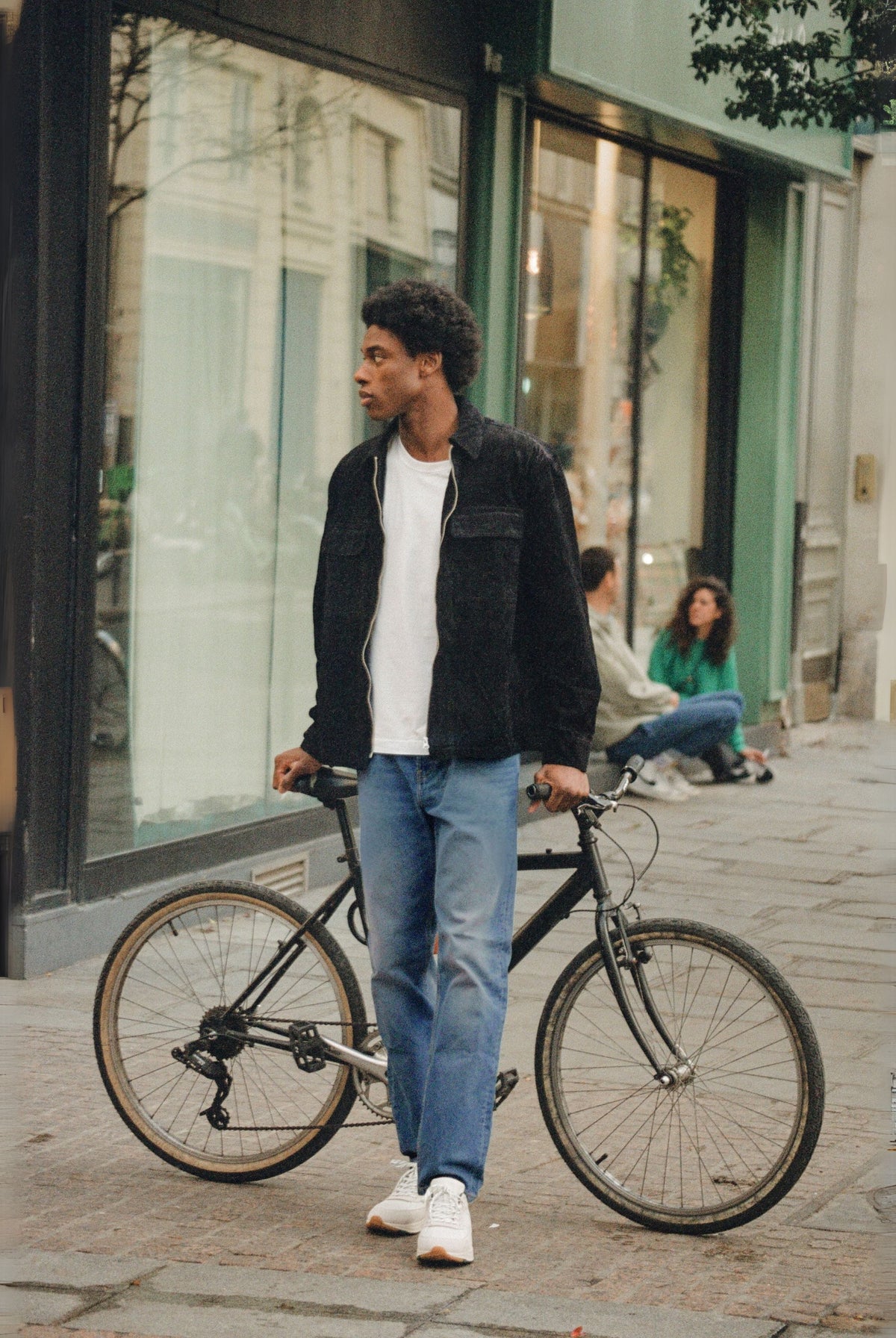 Sustainable MUD Jeans crafted from organic cotton, featuring deep blue denim, paired with a soft gray sweater.