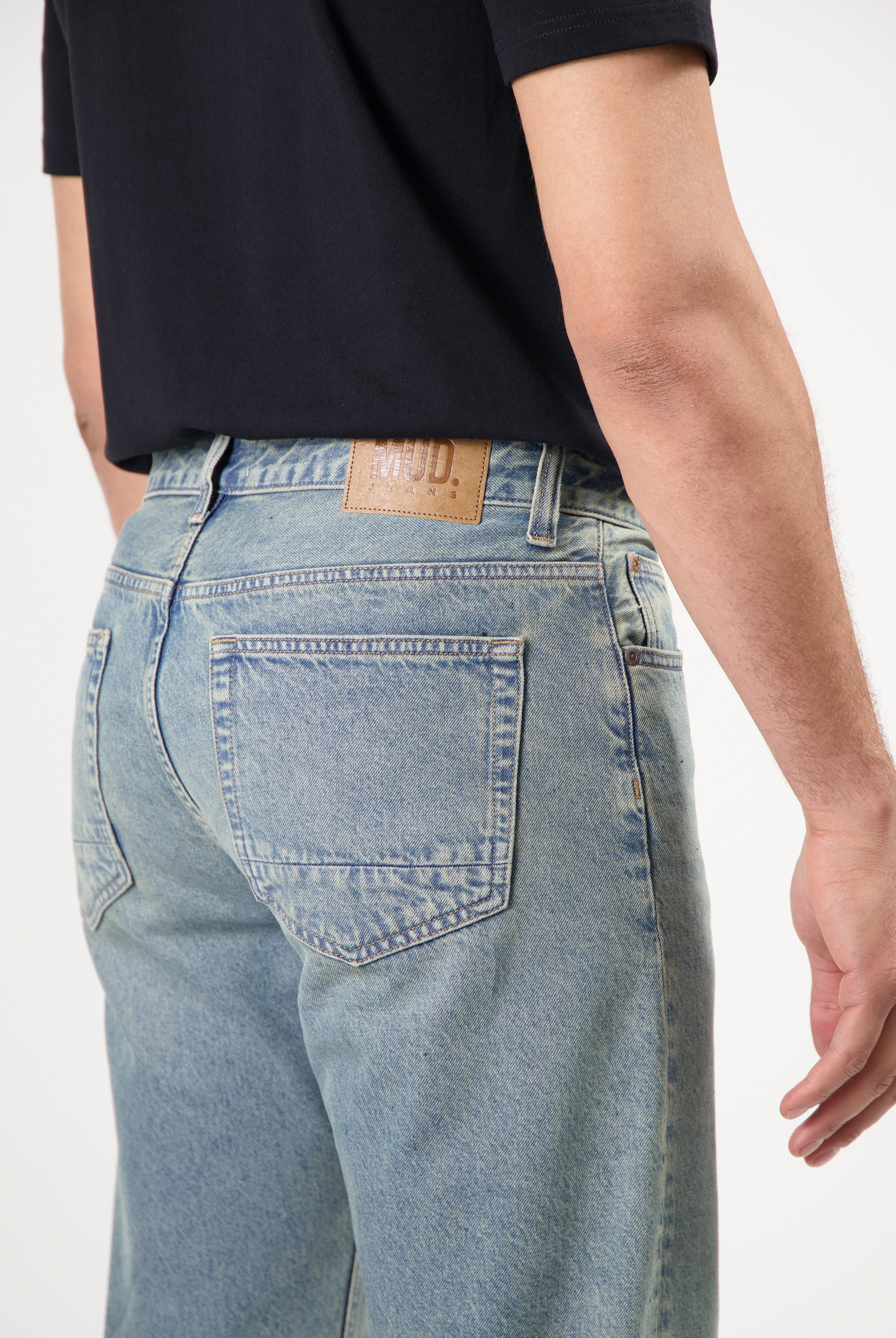 Sustainable MUD Jeans in black denim, featuring a slim fit design, crafted with ethical production methods.