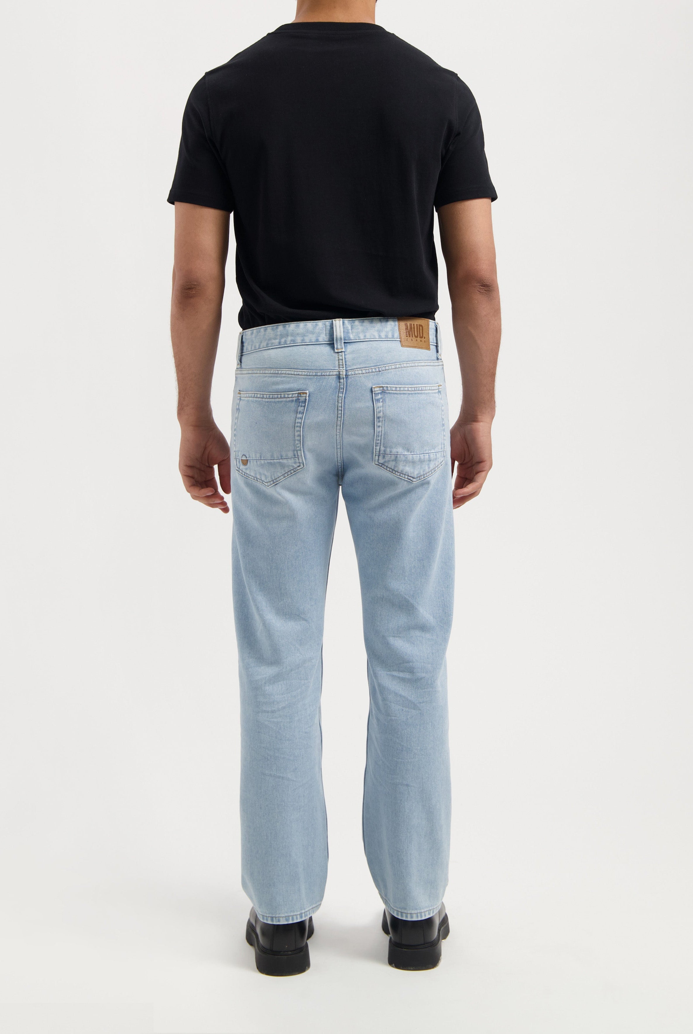 Sustainable MUD Jeans in black, made from organic cotton, featuring a sleek, ethical design in a slim fit.