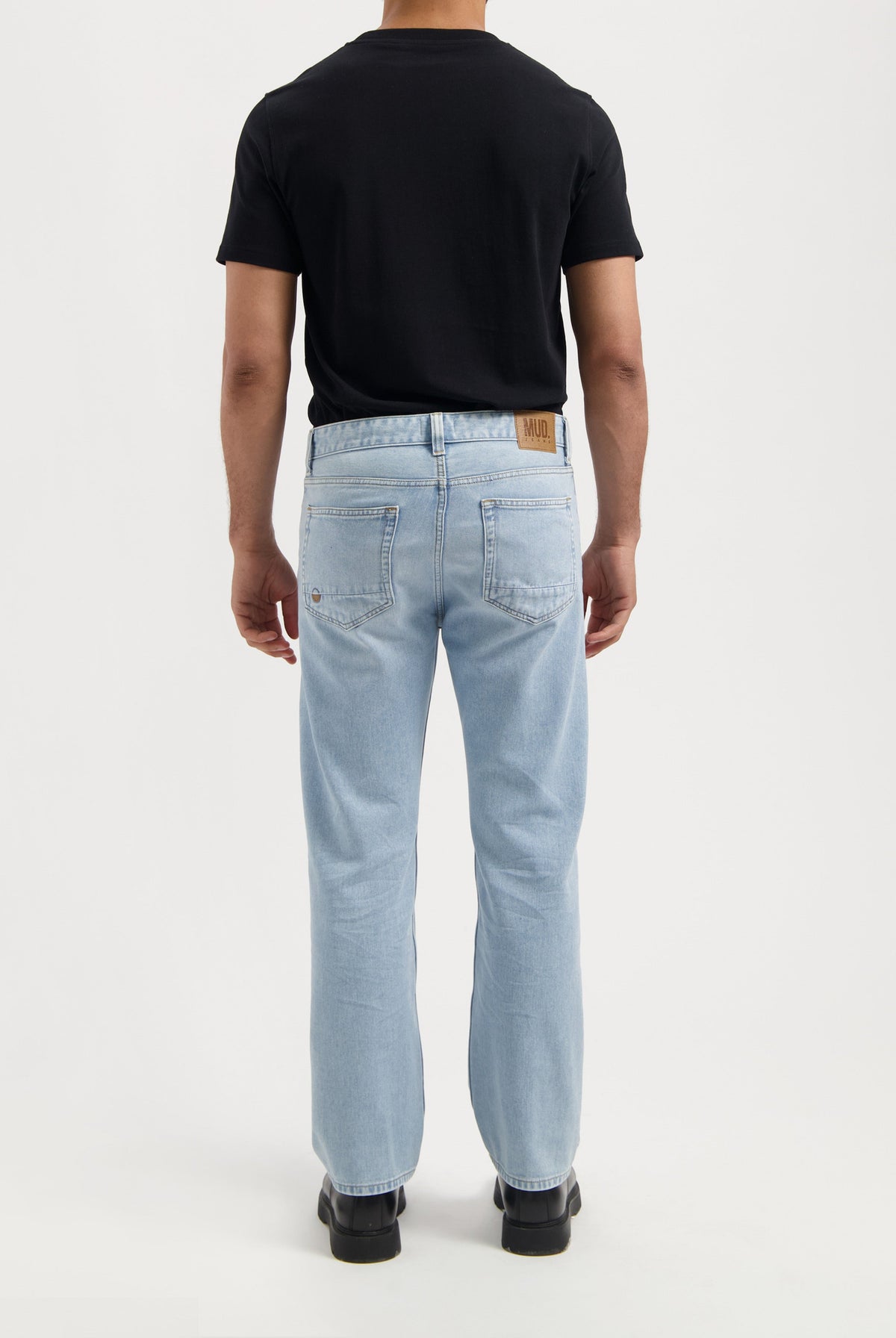Sustainable MUD Jeans in black, made from organic cotton, featuring a sleek, ethical design in a slim fit.