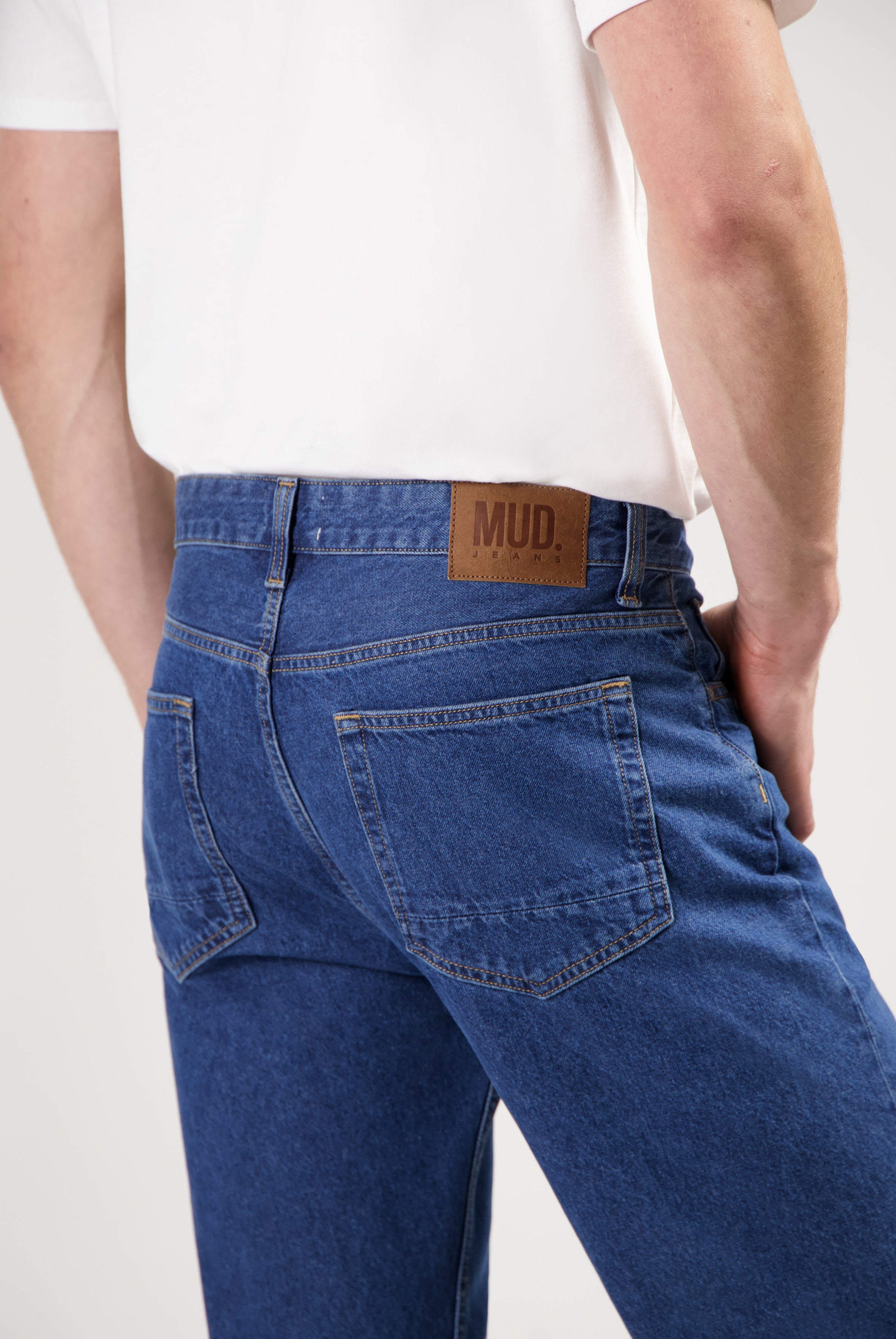 Sustainable MUD Jeans in dark gray denim with a classic fit, promoting ethical fashion and eco-friendly practices.