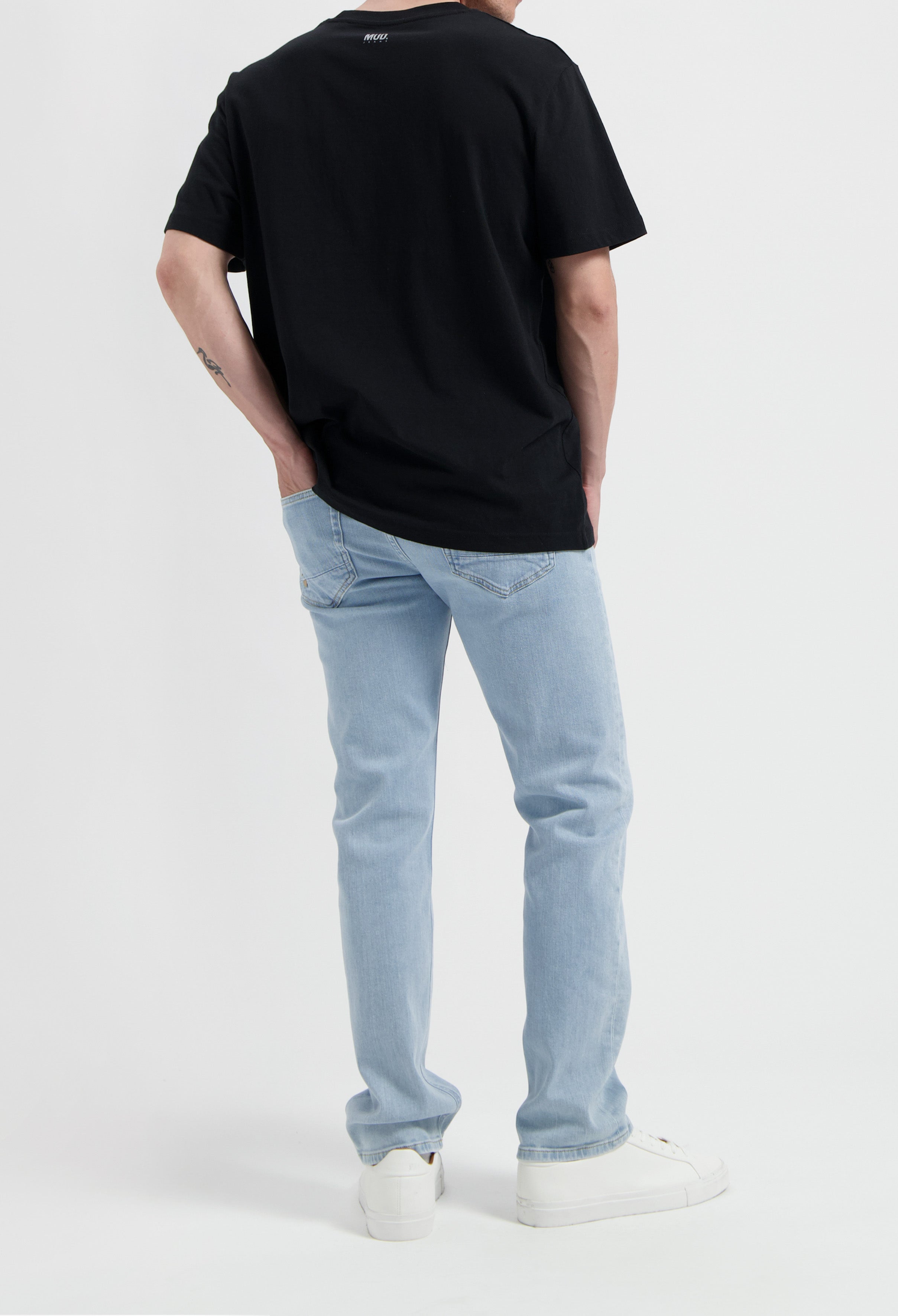 Sustainable MUD Jeans in classic light blue denim, featuring a comfortable straight fit, emphasizing ethical fashion.