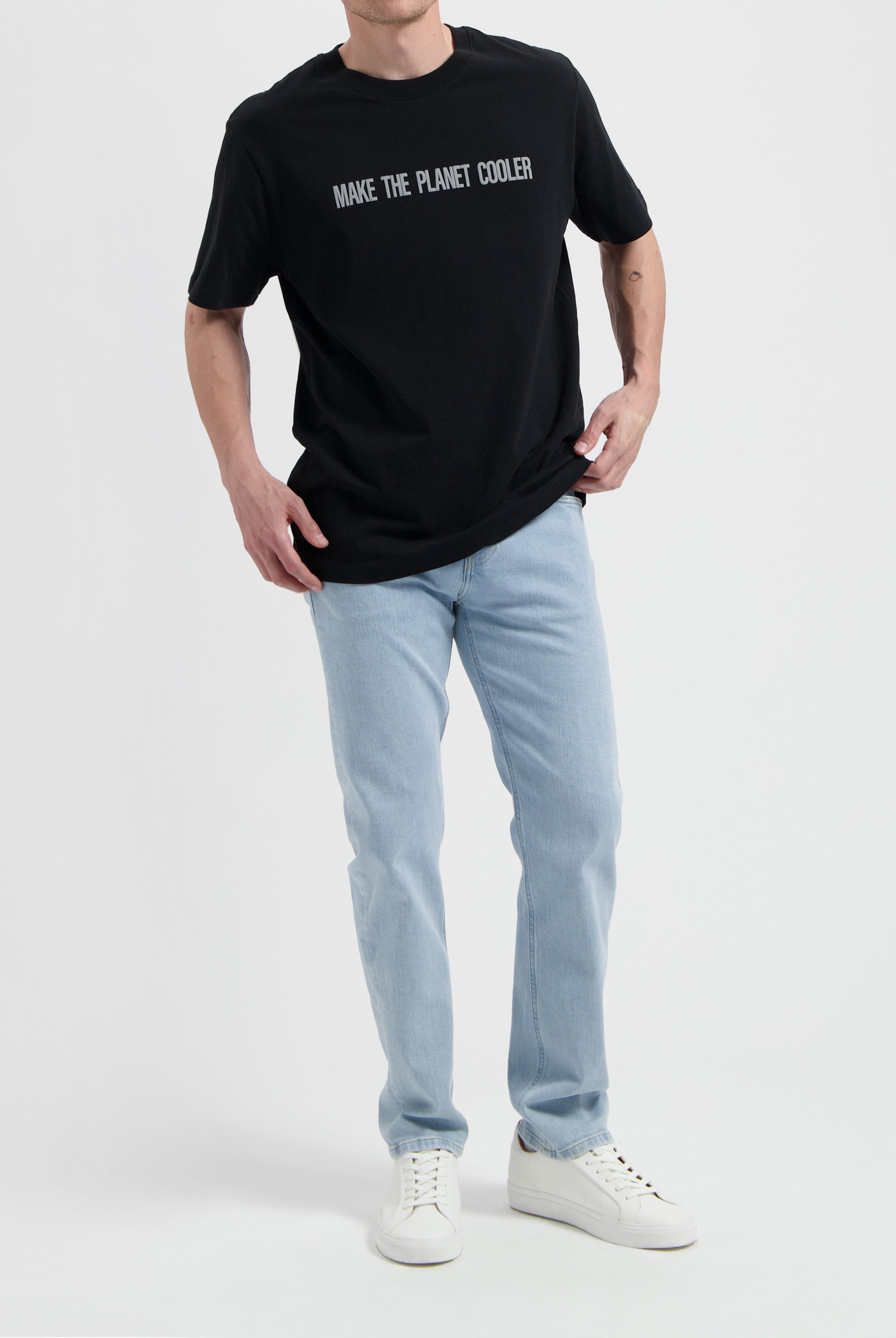 Sustainable MUD Jeans in deep blue denim, ethical and crafted from organic cotton, paired with a classic white t-shirt.