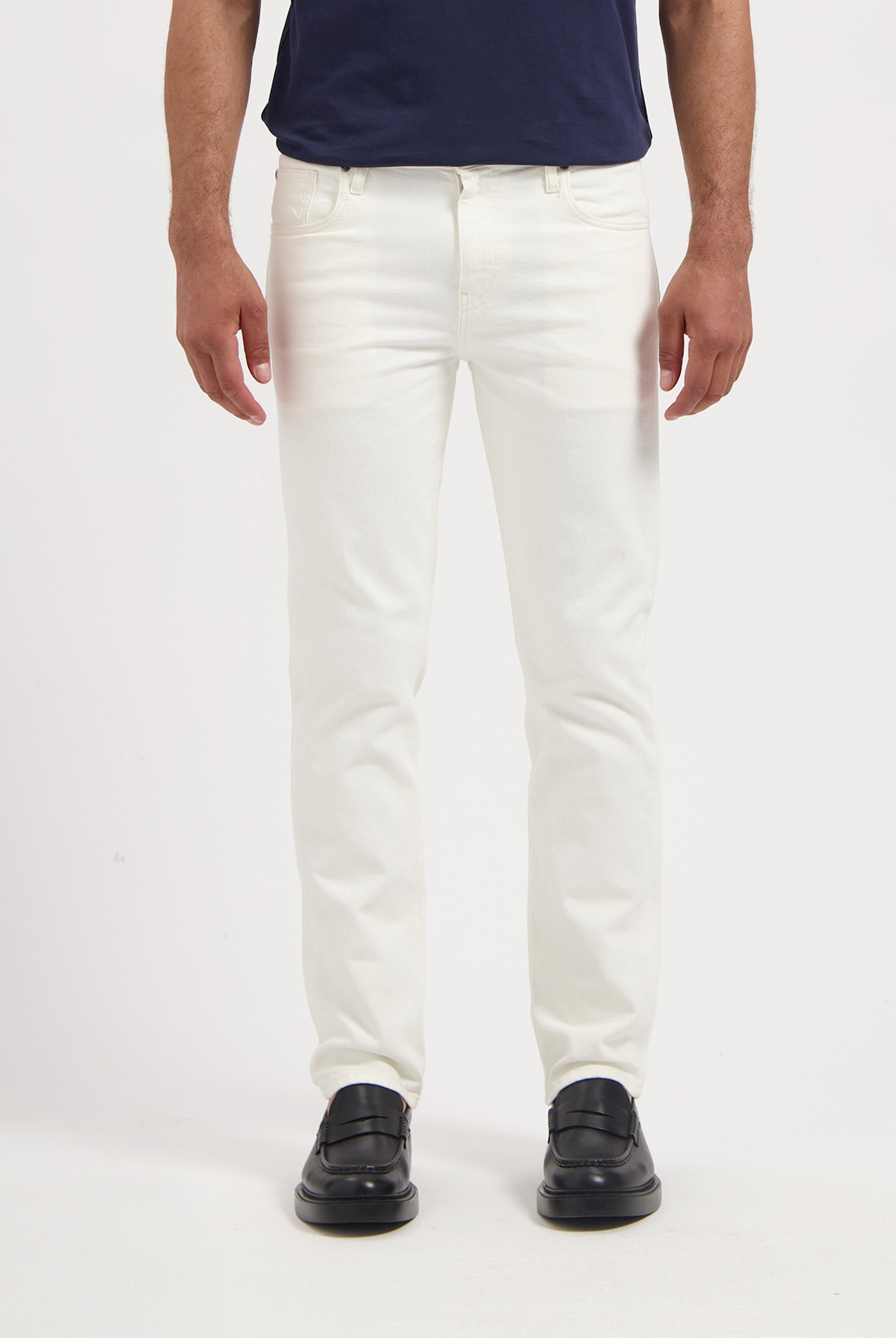 Sustainable MUD Jeans in deep blue denim, classic fit, paired with a black t-shirt, made with ethical practices.