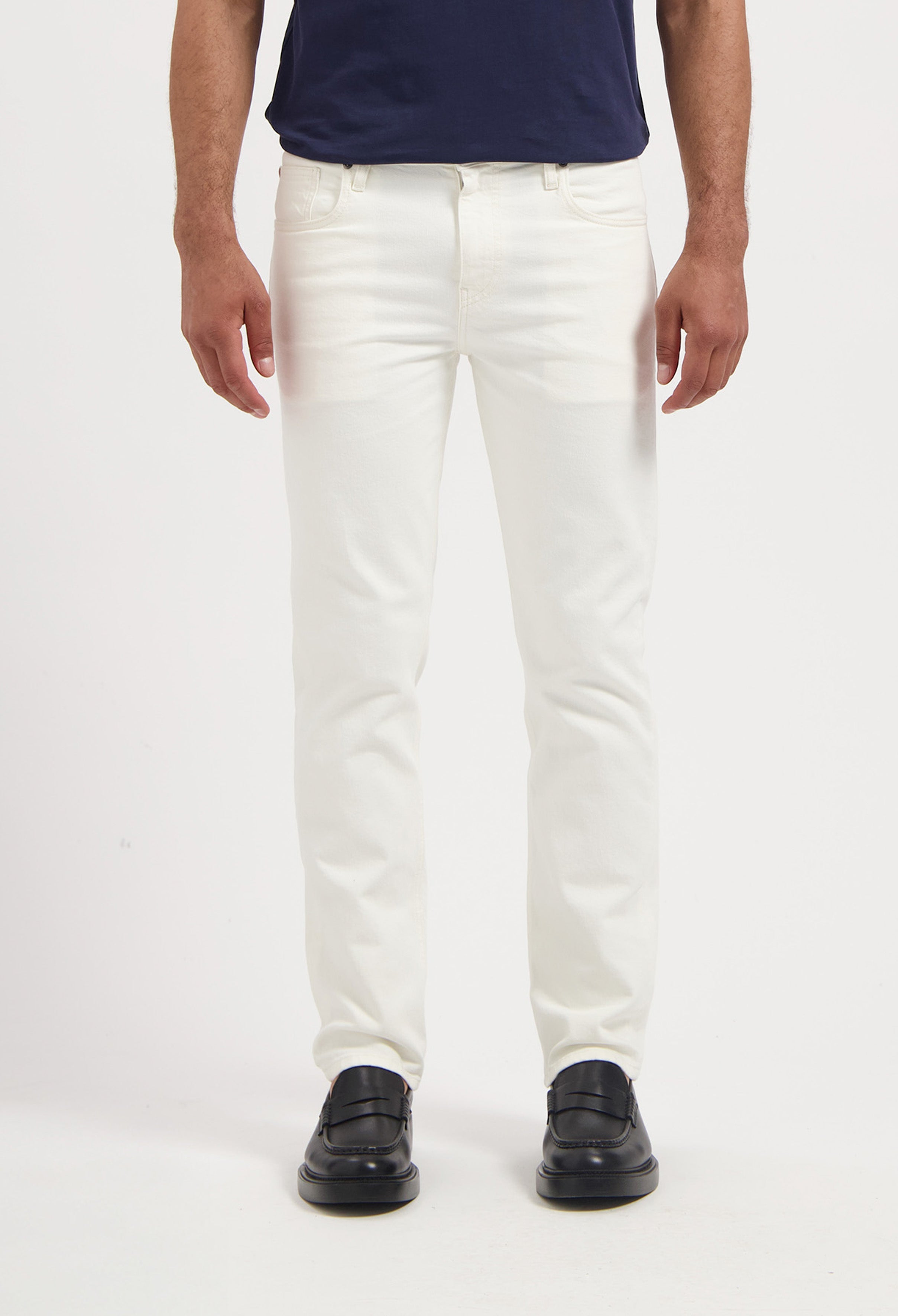 Sustainable MUD Jeans in deep blue denim, classic fit, paired with a black t-shirt, made with ethical practices.