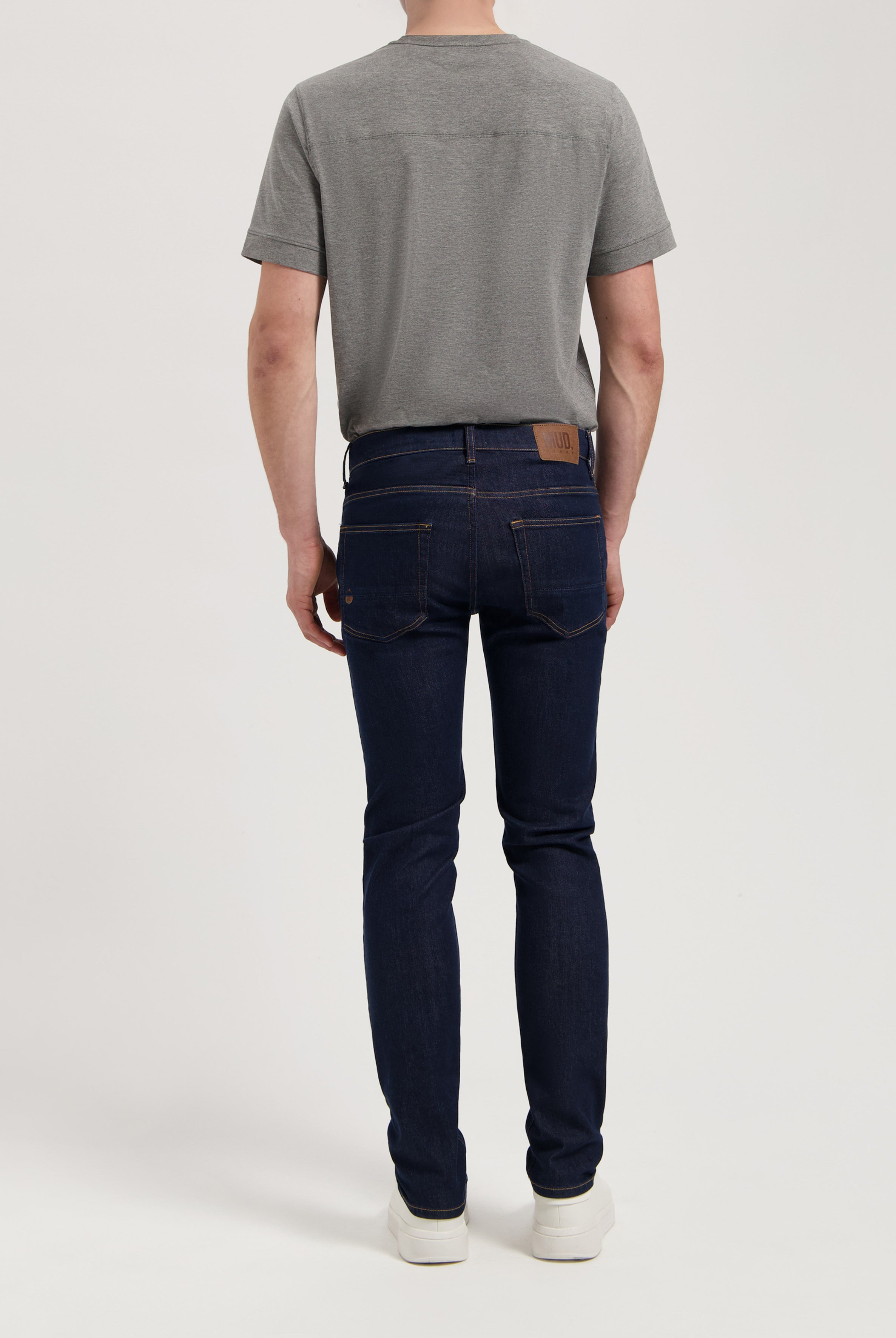 Sustainable Mud Jeans denim shorts in dark blue, showcasing ethical fashion in a relaxed fit, paired with a white tee.