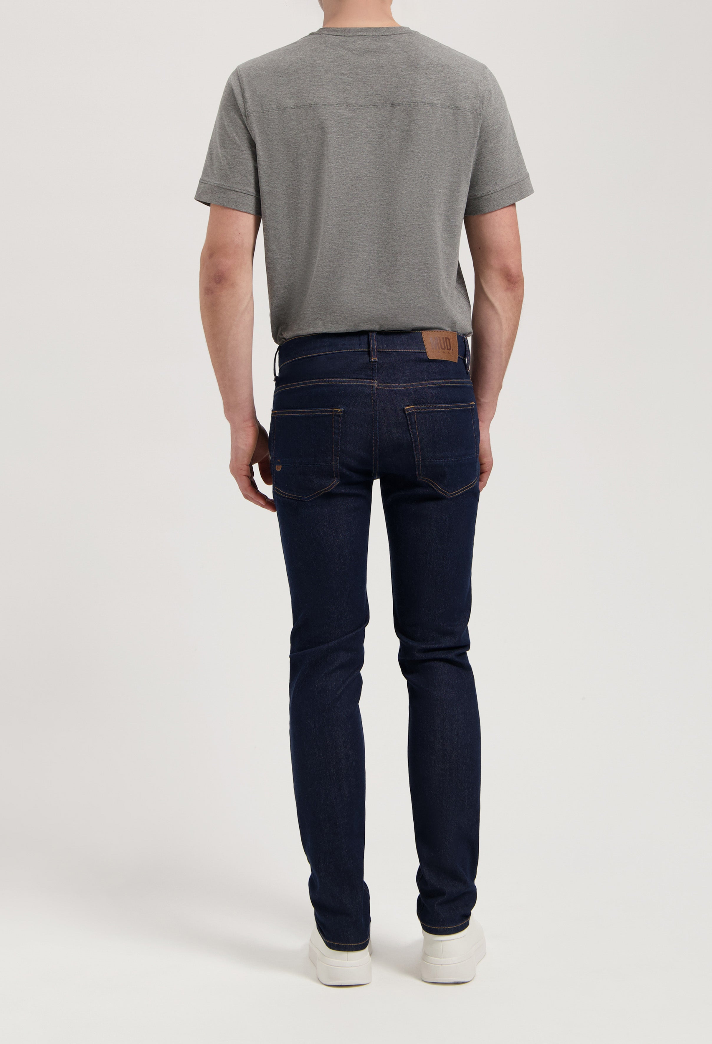 Sustainable Mud Jeans denim shorts in dark blue, showcasing ethical fashion in a relaxed fit, paired with a white tee.