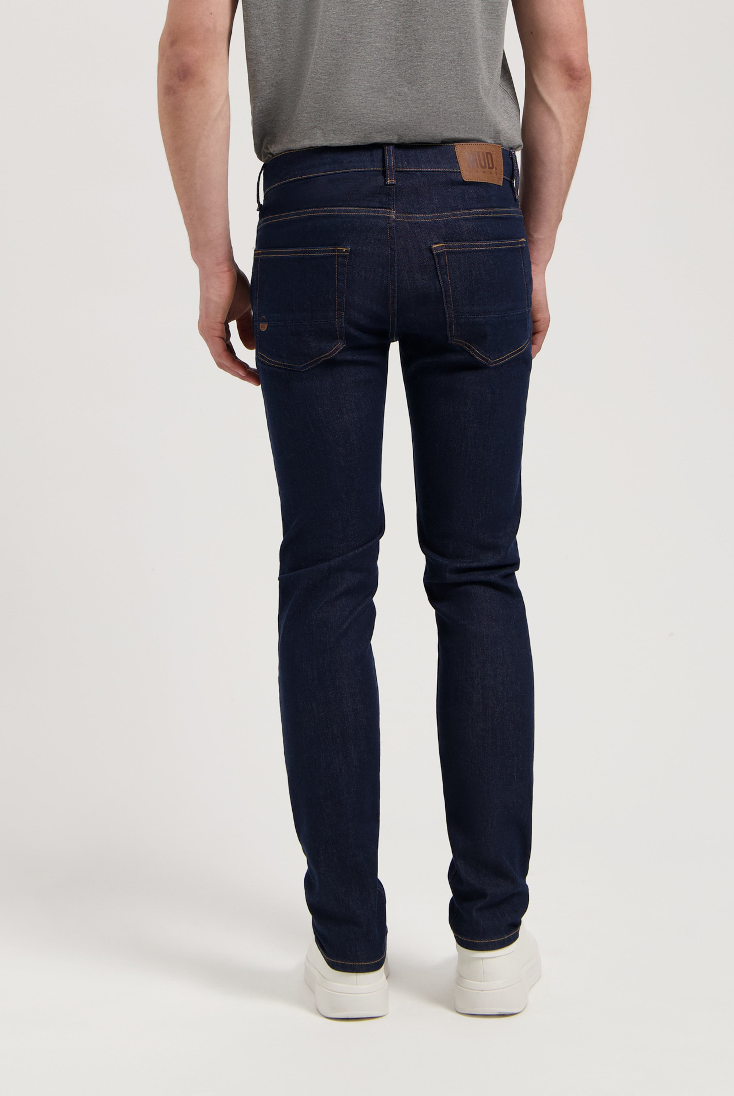 Sustainable MUD Jeans denim shorts in dark blue, paired with a simple white t-shirt, embodying ethical fashion.