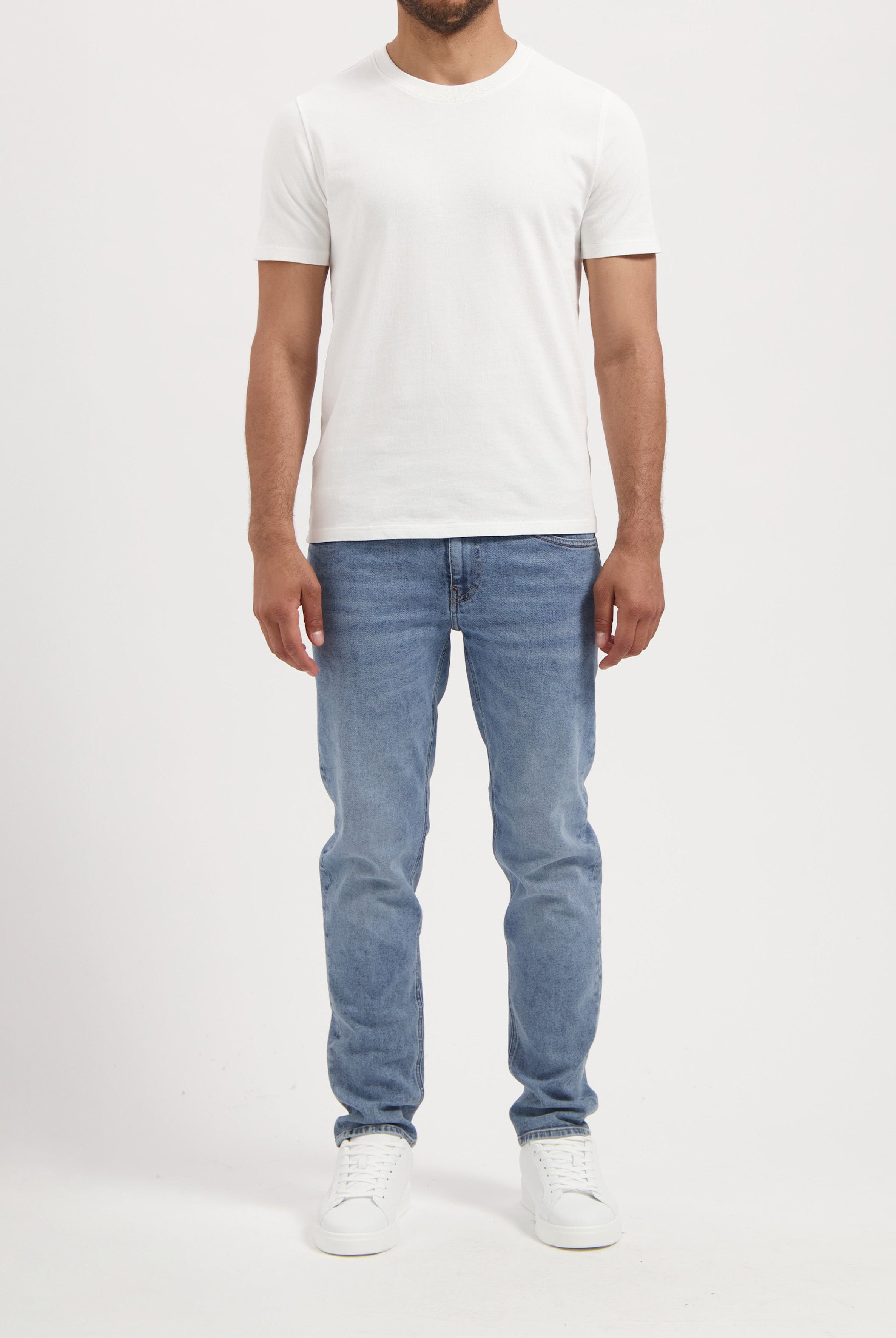 Sustainable MUD Jeans beige shorts, crafted for ethical fashion, paired with casual gray shirt for modern style.