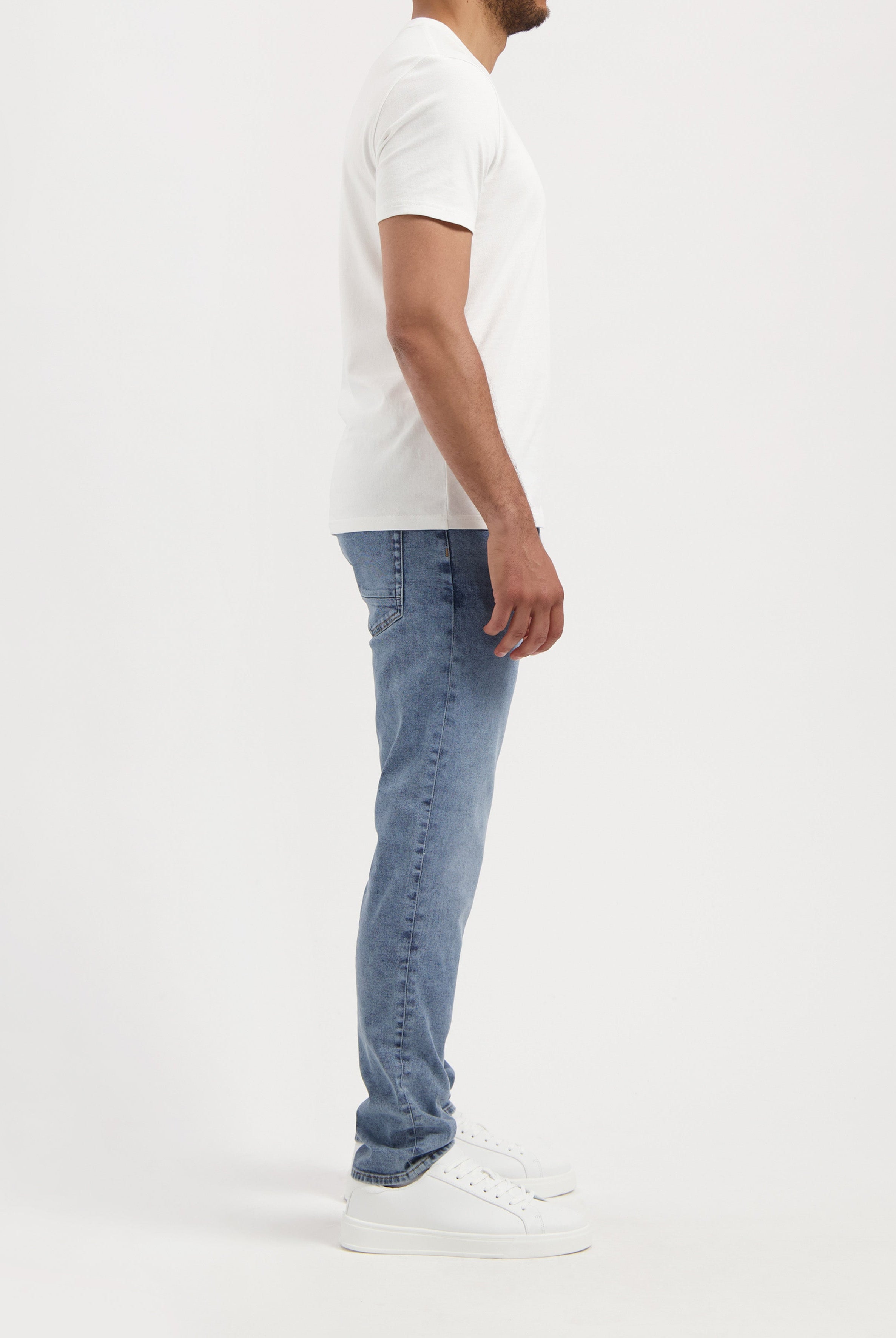 Sustainable Mud Jeans blue shorts, crafted from organic cotton, paired with a black tee, showcasing ethical fashion.