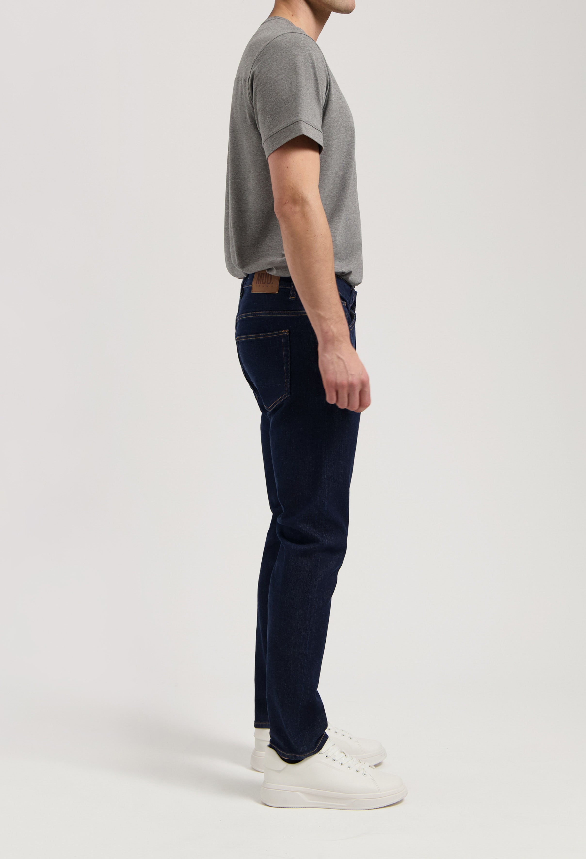Sustainable black denim MUD Jeans with ethical production, paired with a cozy gray sweater for an eco-friendly style.