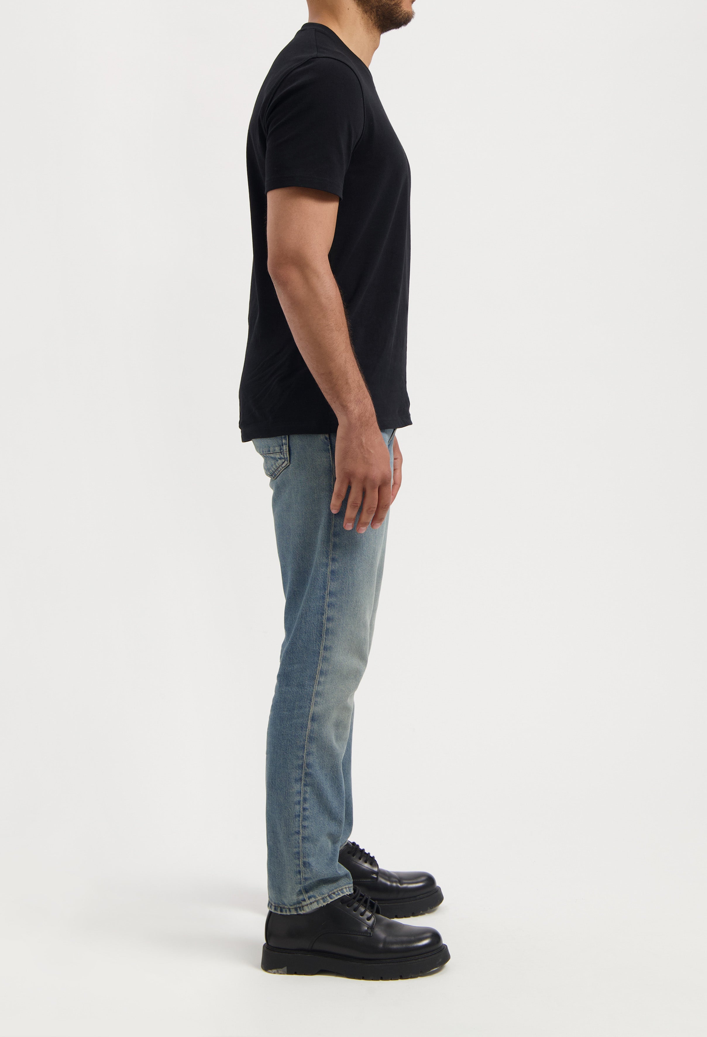 Sustainable MUD Jeans navy cotton shorts paired with matching navy t-shirt, emphasizing ethical fashion choices.