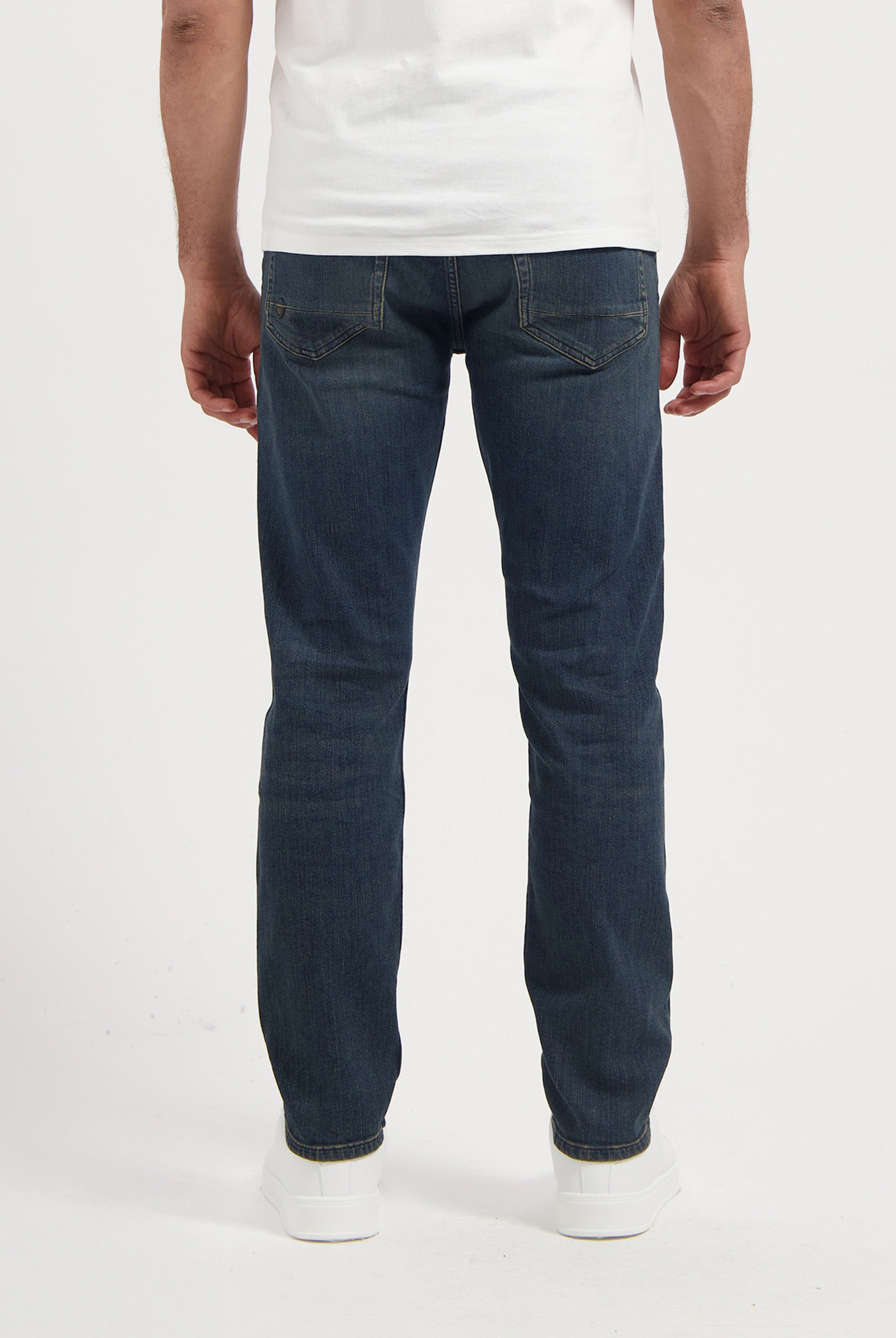 Sustainable MUD Jeans in light blue denim, crafted for comfort and style, paired with a classic black tee.