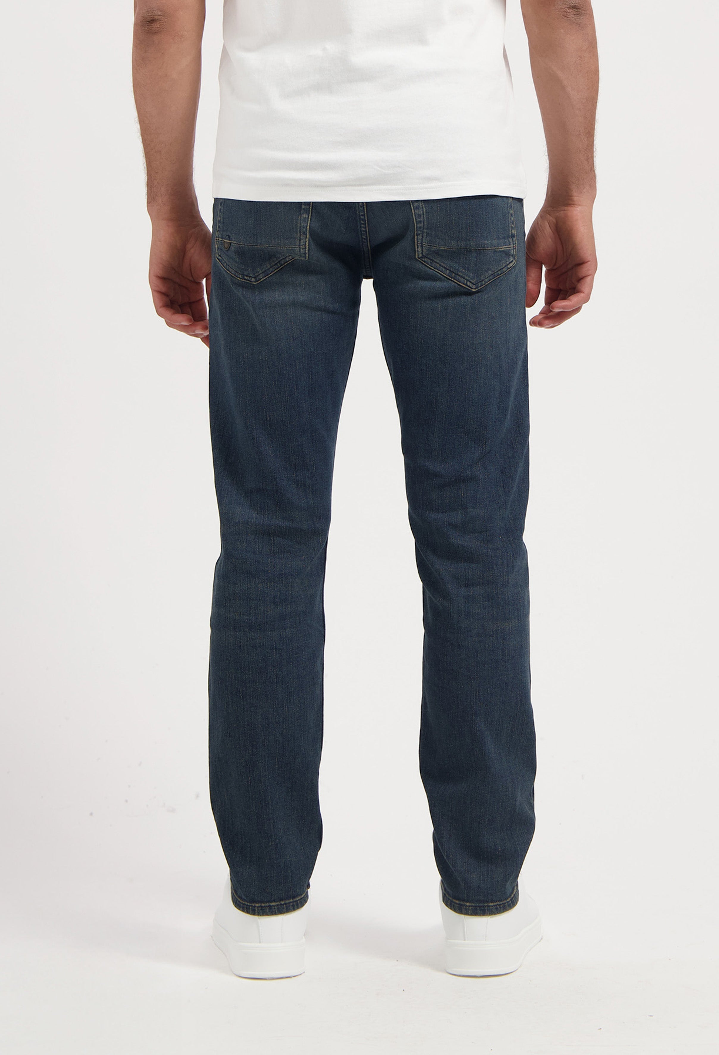 Sustainable MUD Jeans in light blue denim, crafted for comfort and style, paired with a classic black tee.