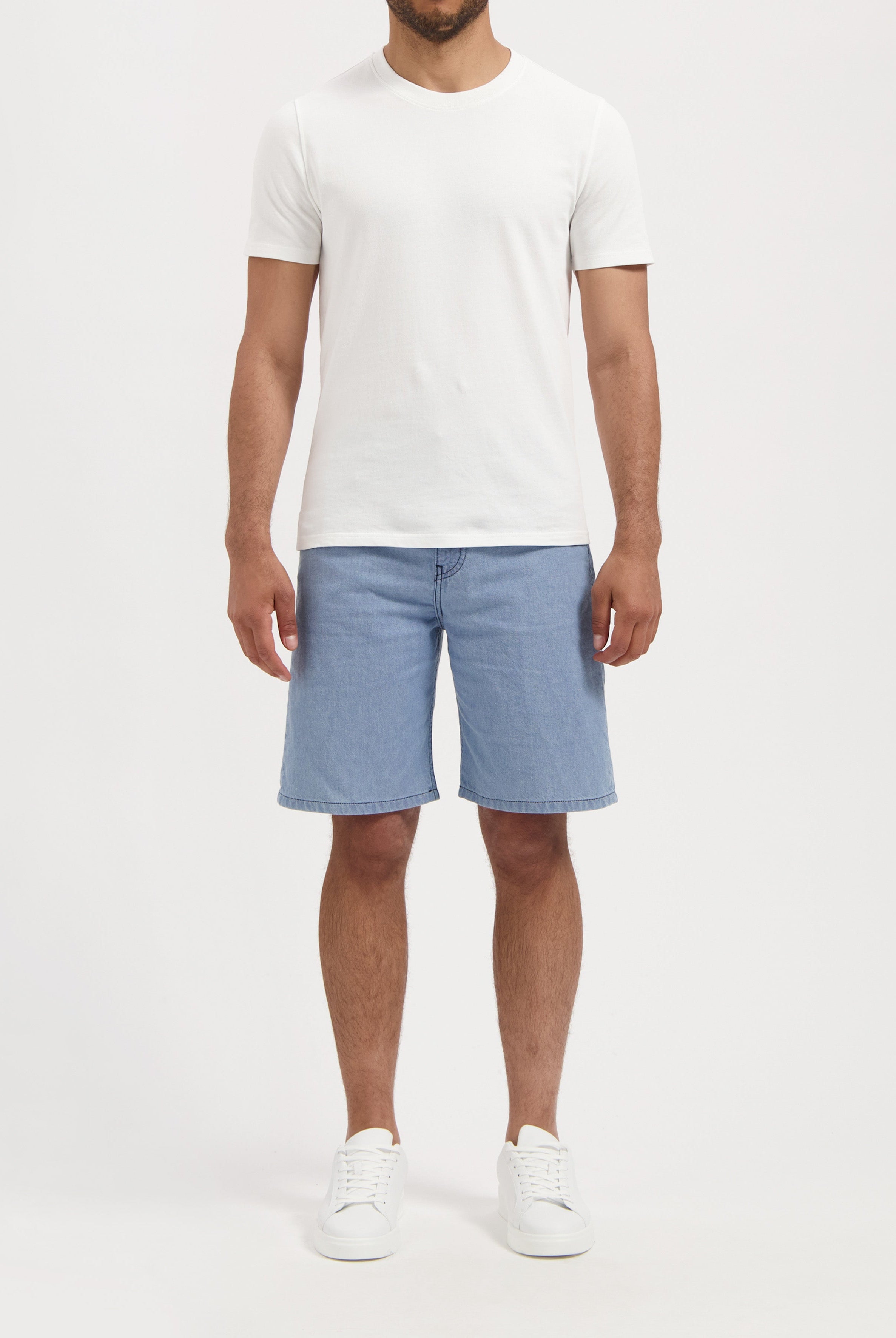 Sustainable MUD Jeans in classic black denim, crafted for ethical fashion, paired with a cozy gray sweater.