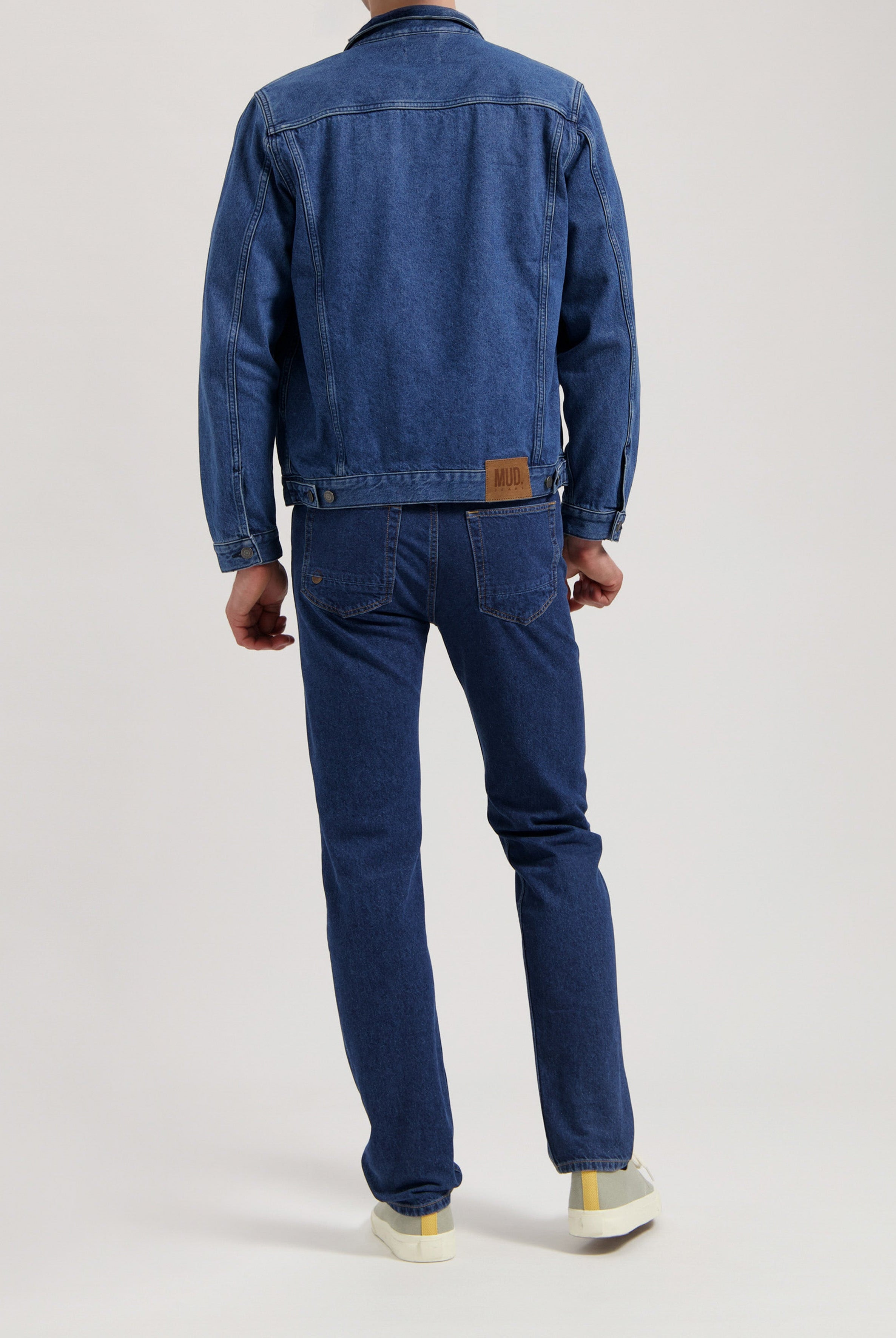 Sustainable MUD Jeans in dark blue, crafted from organic materials, offering an ethical fit with minimalist pockets.