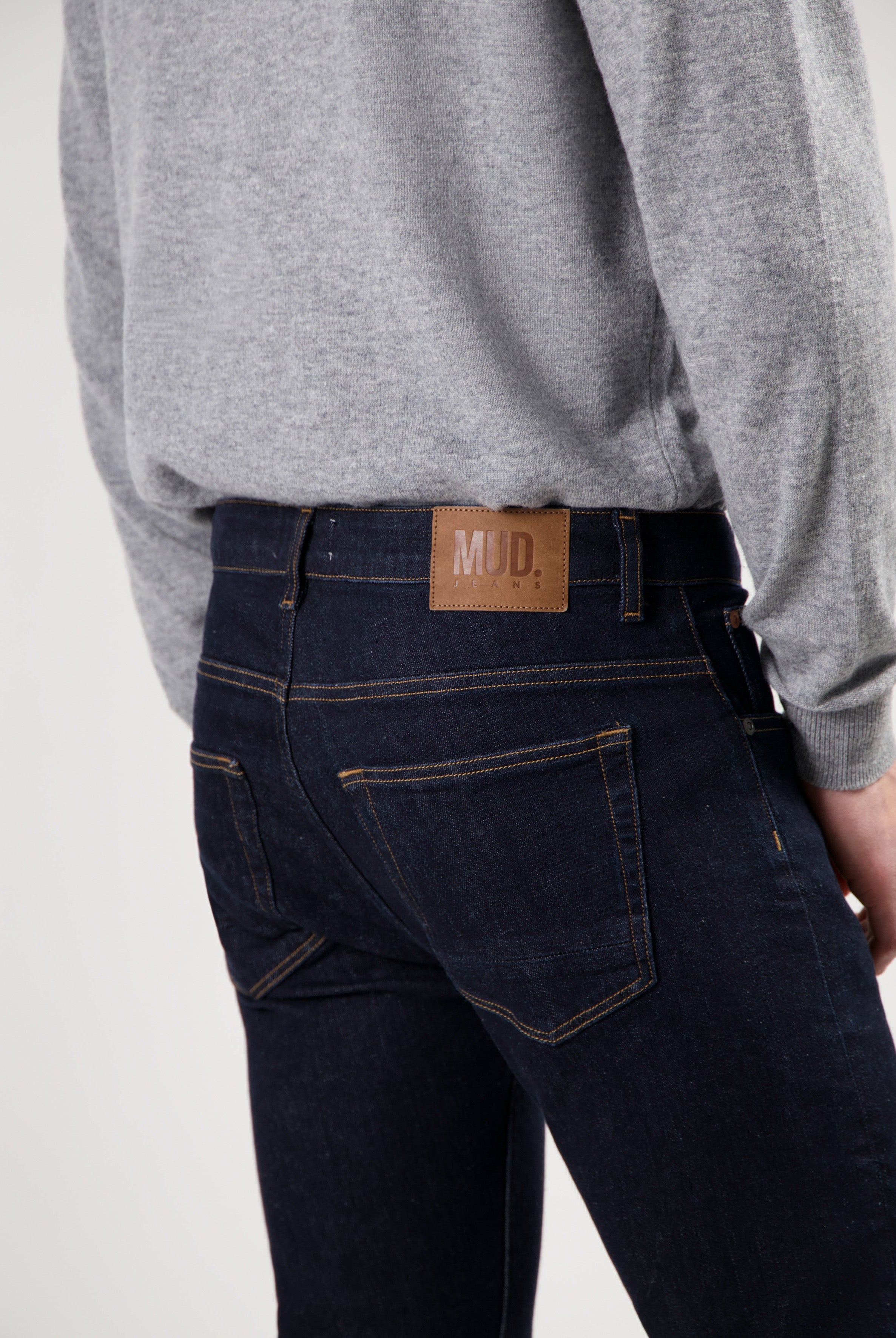 Sustainable MUD Jeans in dark denim, crafted from organic cotton, offering an ethical choice for modern casual wear.