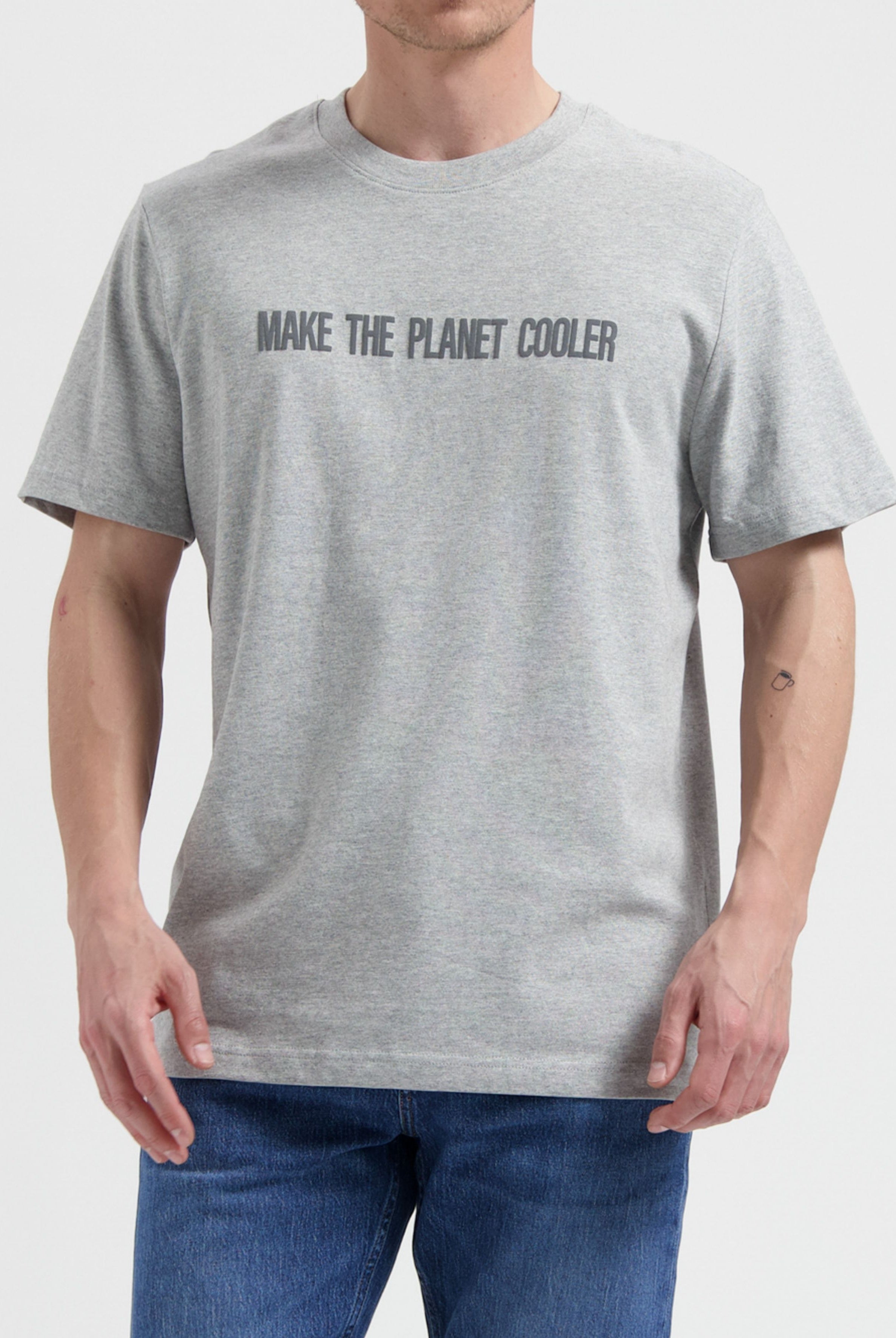 Gray cotton t-shirt with "Make the Planet Cooler" slogan, paired with classic blue denim jeans on a neutral background.