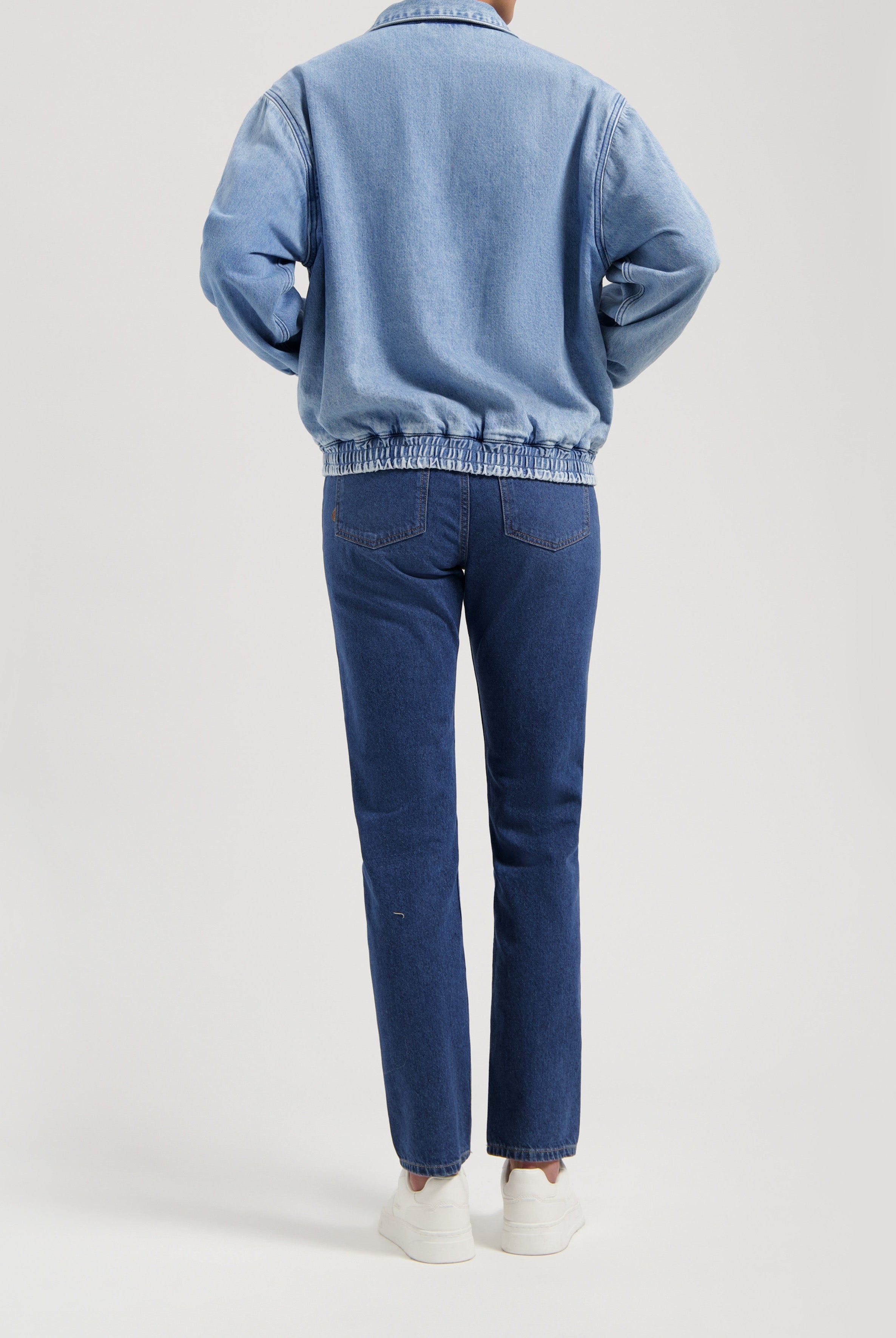 Casual blue denim jacket paired with matching blue jeans, showcasing a relaxed fit and elastic waistband design.