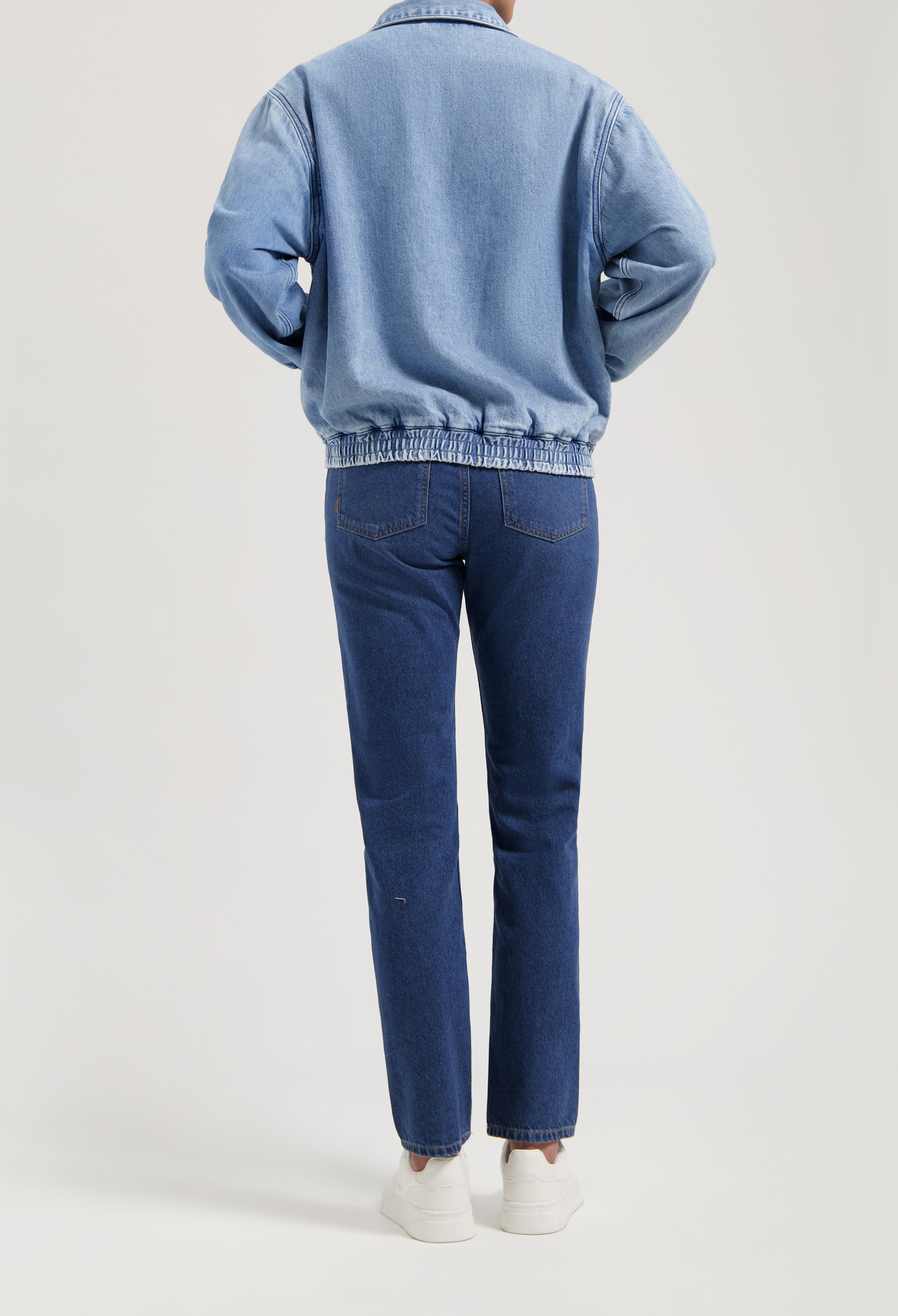 Casual blue denim jacket paired with matching blue jeans, showcasing a relaxed fit and elastic waistband design.