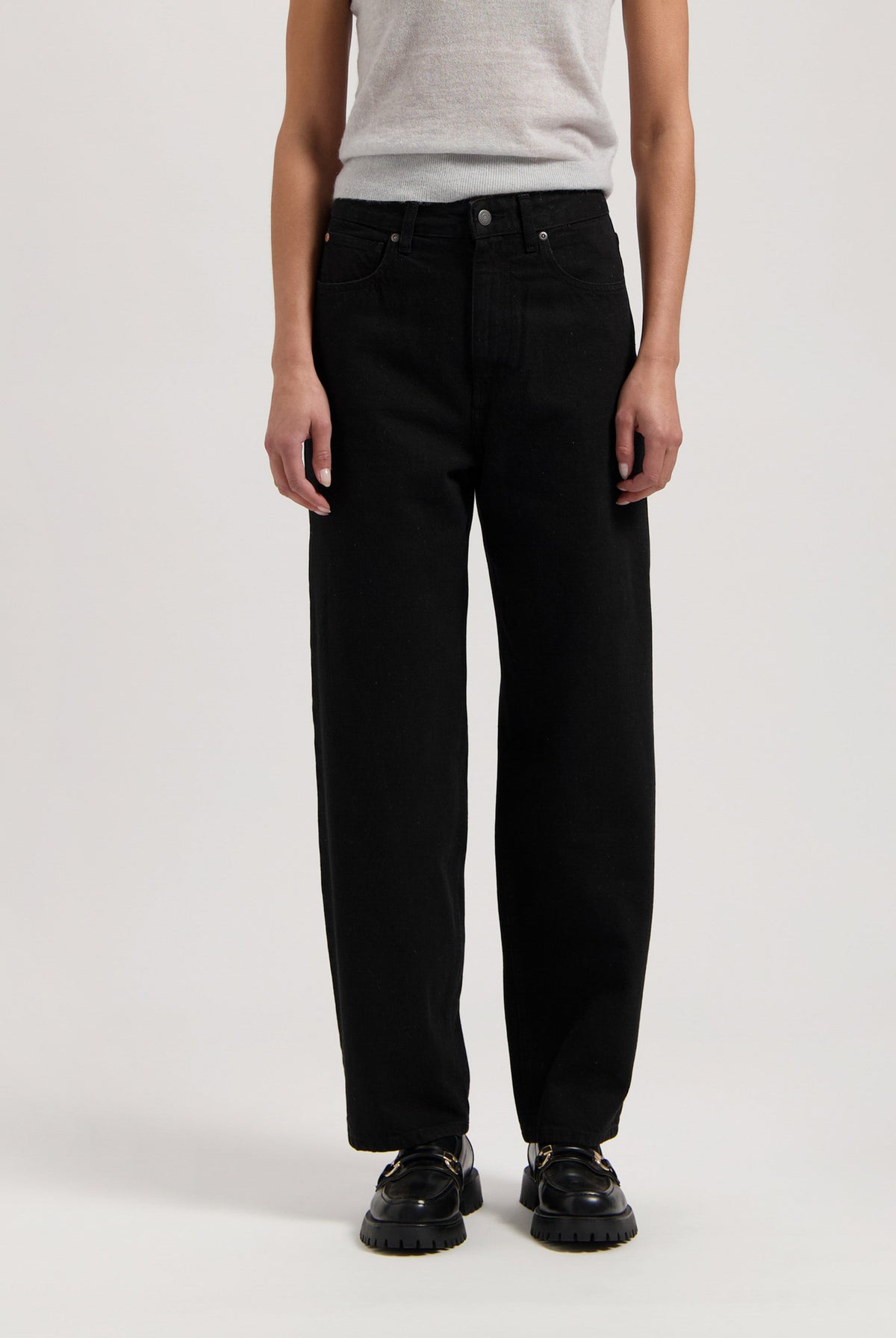 Wide-leg black pants paired with a sleeveless gray top, showcasing a casual and minimalist fashion style.