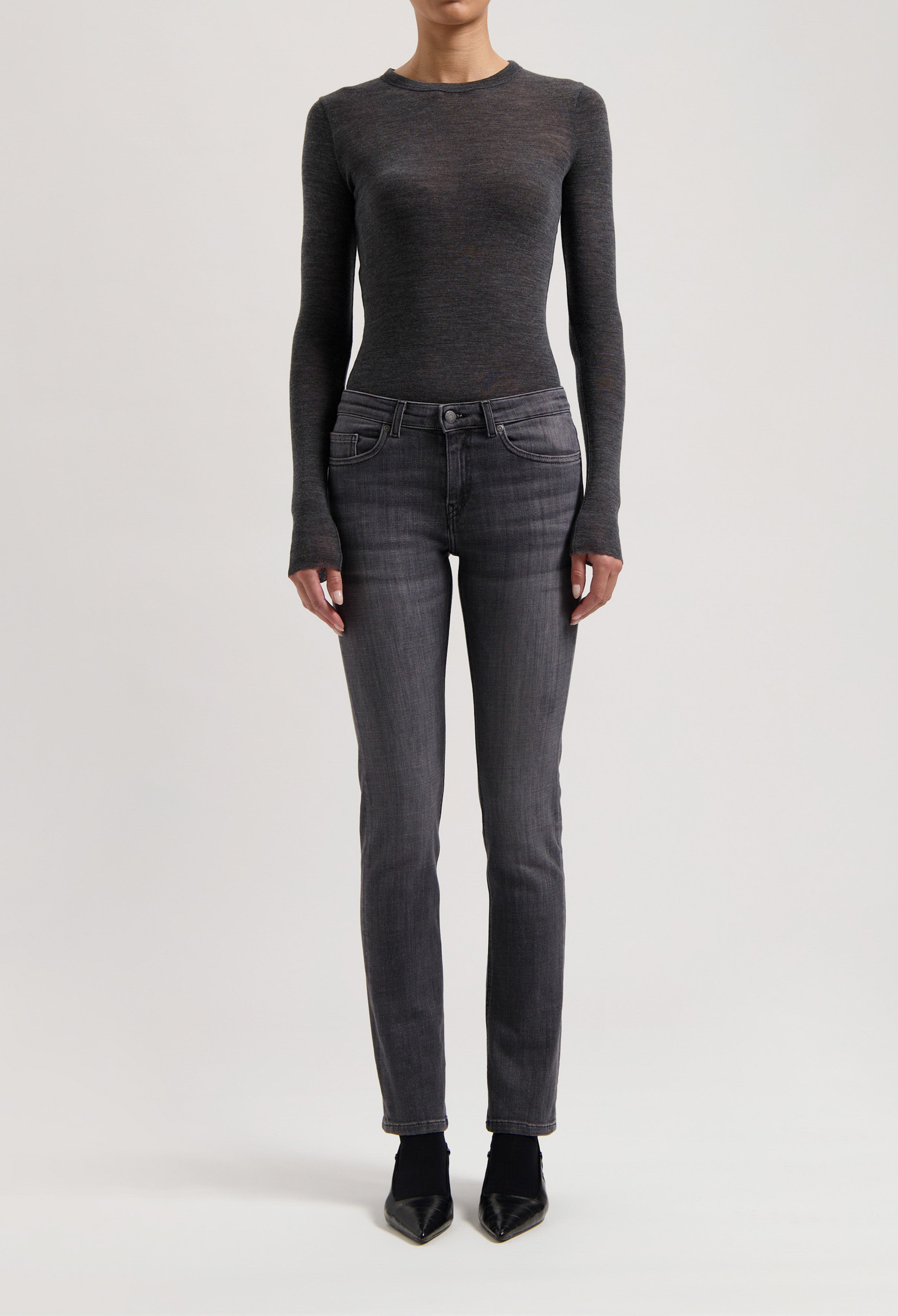 A sleek dark gray long-sleeve top paired with charcoal slim-fit jeans, highlighting a minimalist, modern fashion look.