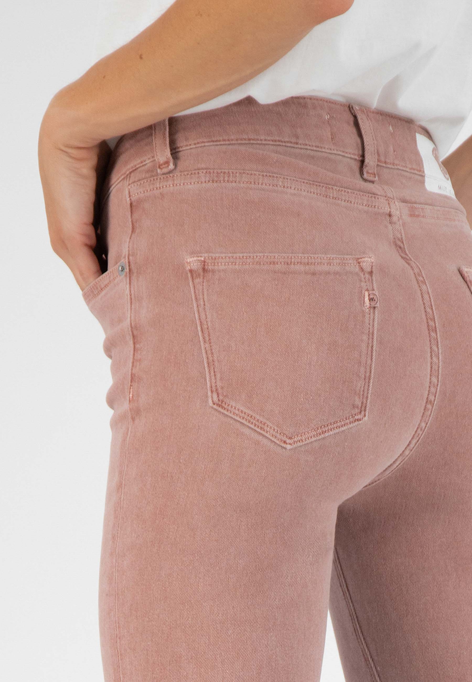 High-waisted pink denim jeans with a classic fit, shown from the back, paired with a white casual top.