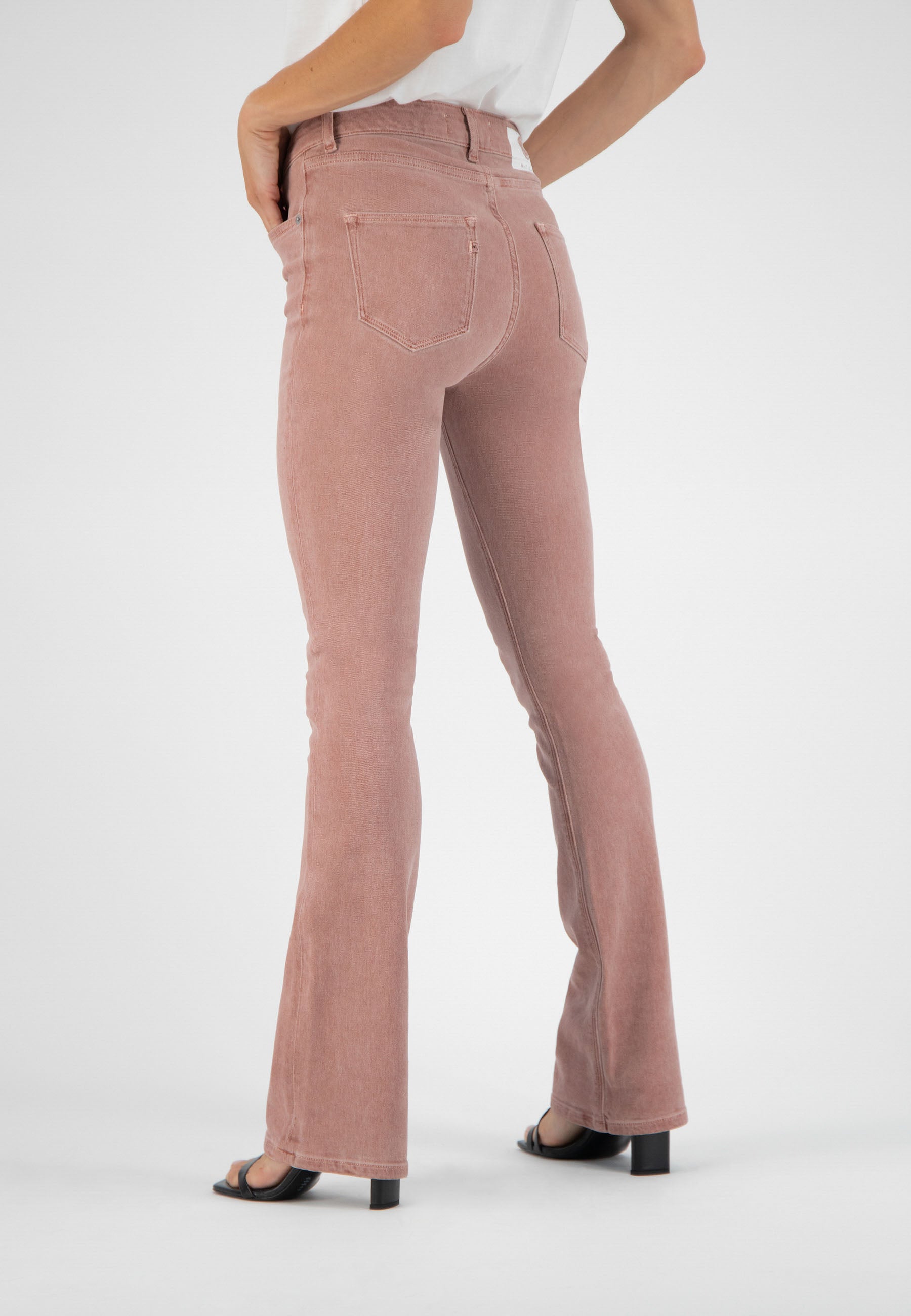 High-waisted flared jeans in a dusty pink hue, showcasing a back view with classic five-pocket design and subtle stitching.