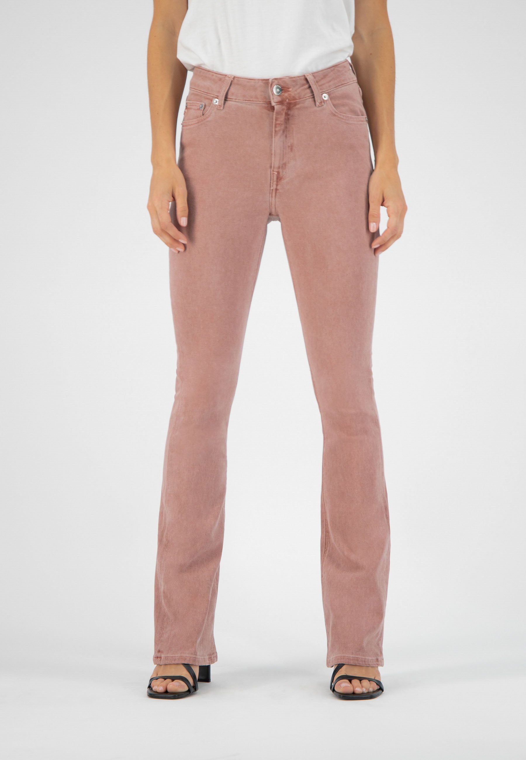 High-waisted rose-colored denim jeans in a flattering fit, paired with a simple white top and black sandals.