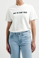 Sustainable Mud Jeans crafted from eco-friendly denim in light blue, paired with a white ethical slogan tee.