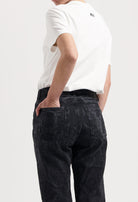 Sustainable MUD Jeans in light blue denim, ethical classic fit, paired with a crisp white T-shirt, rear view.