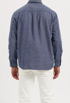 Sustainable Mud Jeans in deep indigo denim, crafted with organic cotton, paired with a black T-shirt.