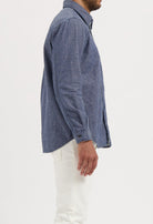 Sustainable MUD Jeans featuring dark blue denim, crafted from ethical materials, shown with a black t-shirt.