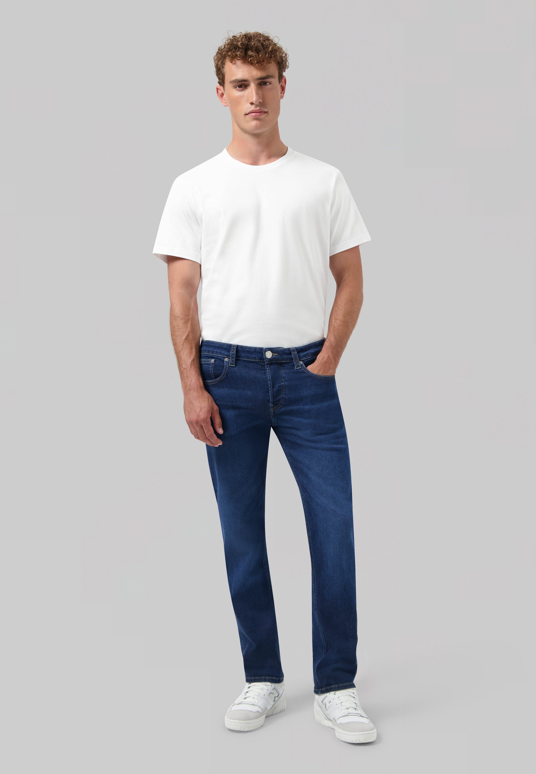 Sustainable blue denim jeans by MUD Jeans, featuring a classic fit, highlighting ethical fashion and organic materials.