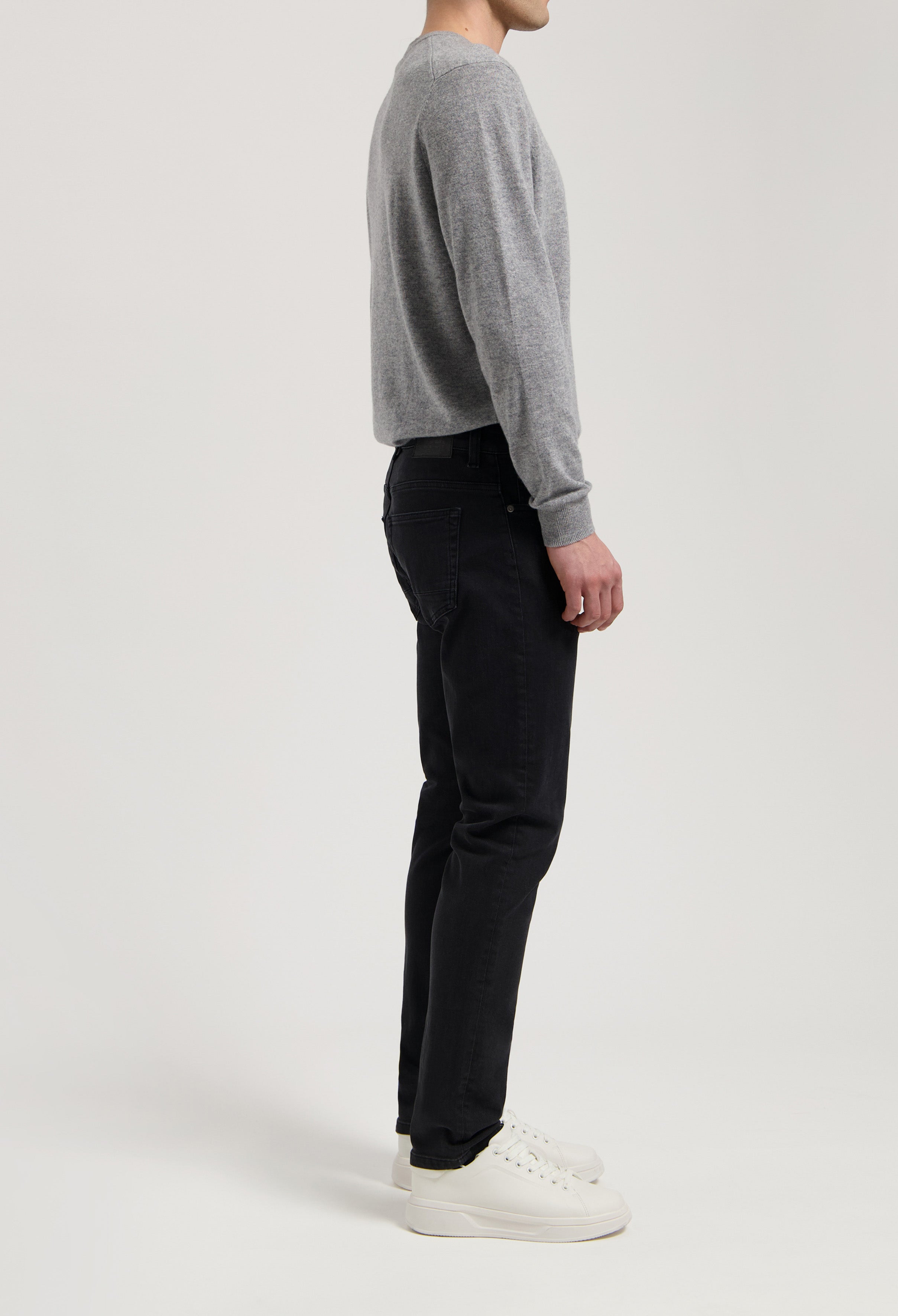 Sustainable MUD Jeans in deep blue denim, crafted ethically, styled with matching denim jacket, showcasing eco-friendly fashion.